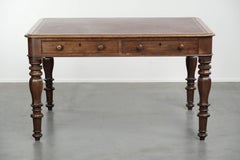 Antique English writing desk from the 19th century with a red leather top