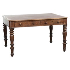 Antique English writing desk from the 19th century with a red leather top