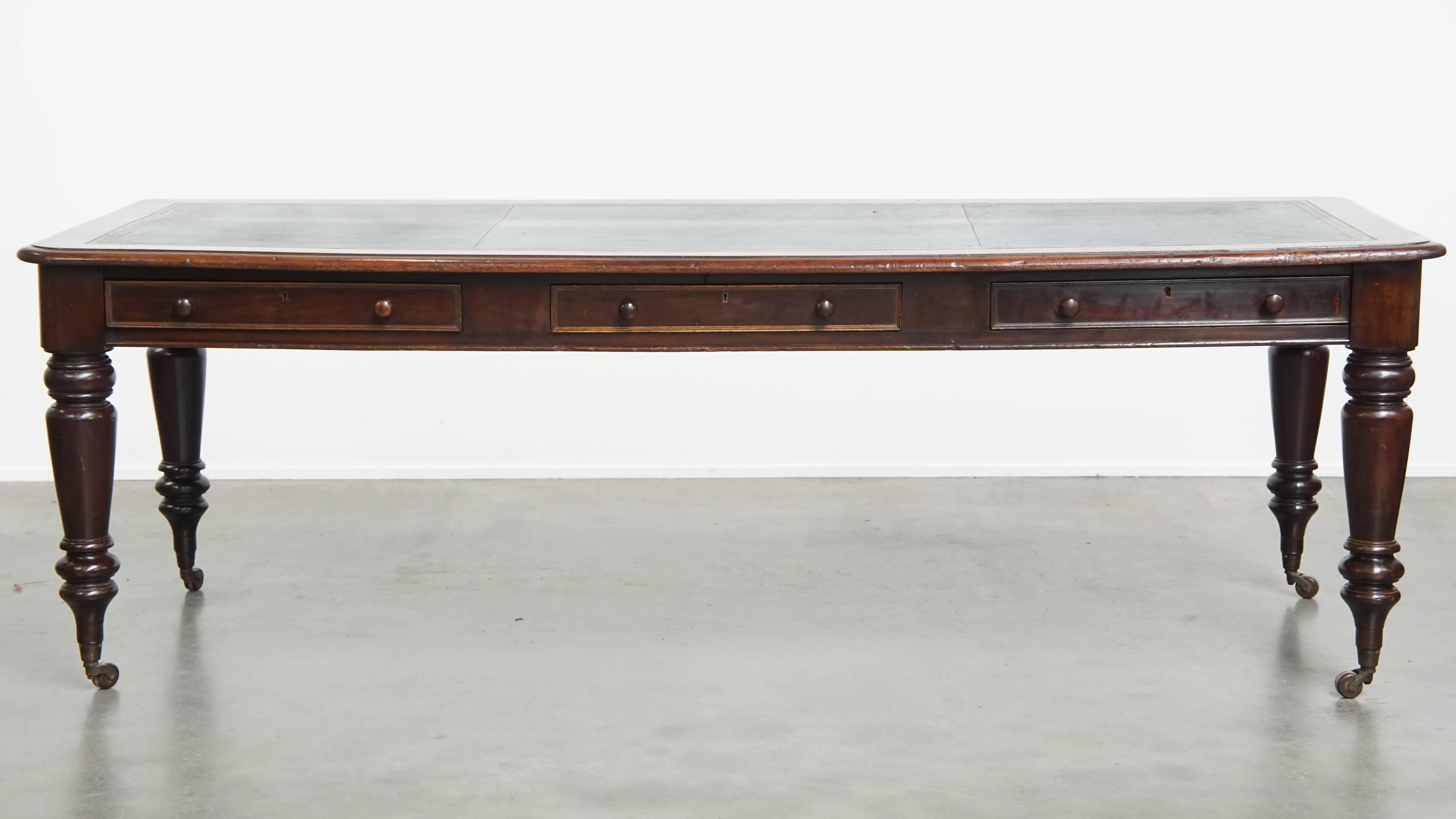 Offered here this long, unique antique English writing table / partner desk with a blue leather top, dating from the mid-19th century.
This magnificent antique English desk is a luxurious addition to almost any space, whether in your home or, for
