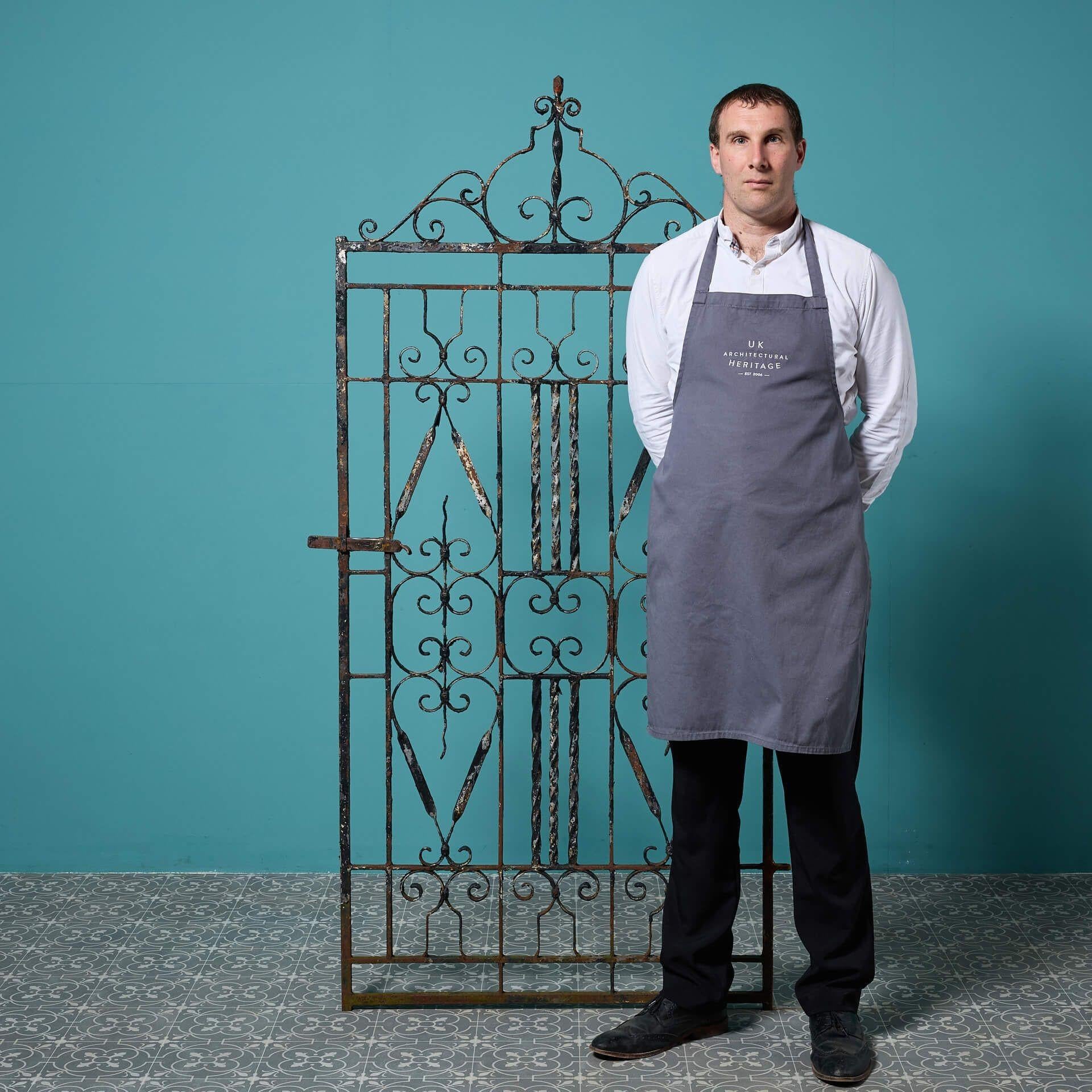 A stunning tall antique wrought iron pedestrian gate in Victorian style, handcrafted by a talented early 20th century blacksmith.

Standing at 1.8m tall, this wrought iron gate is perfect for the side of a house or a narrow courtyard, the elaborate