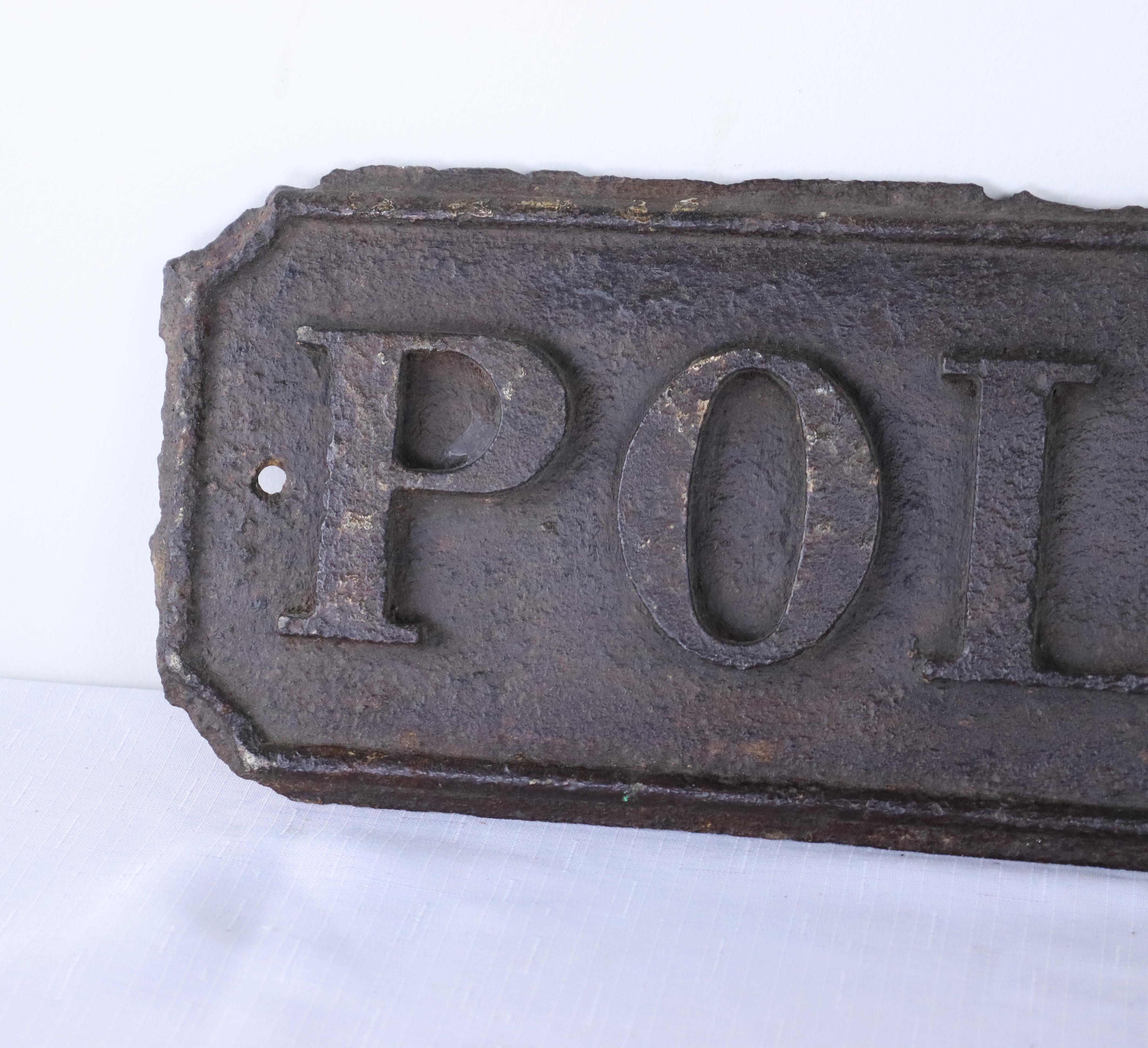 An antique English wrought iron police station sign in good original condition. Manufactured at the Briggs Foundry, Barrow, as seen in the bottom right corner. There are holes at either end for easy display. Quite heavy.