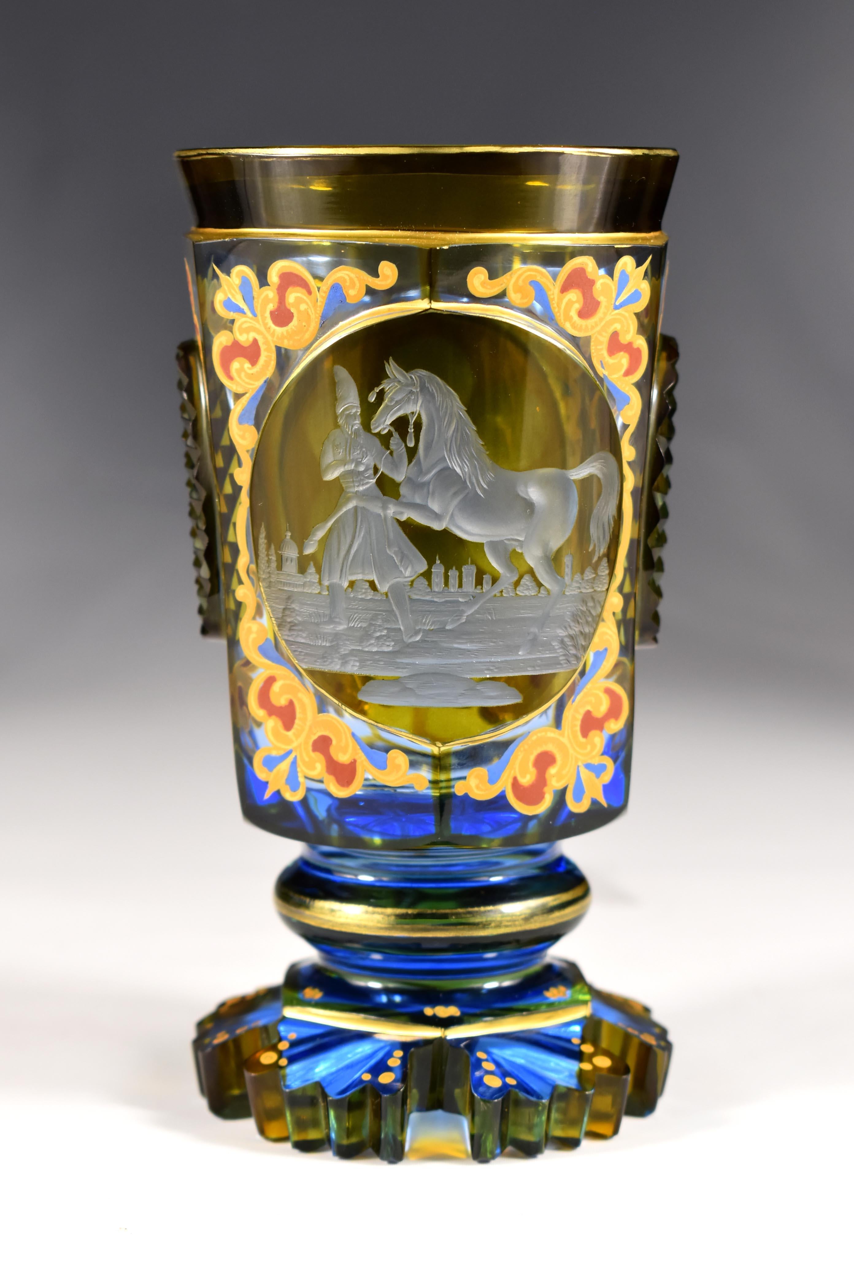 A goblet of blue glass, cut and with a yellow lazure , cut two medallions, in the first one there is an engraving of a Persian horse, In the second medallion are cut diminutive windows, Everything is complemented by an ornamental painting that is