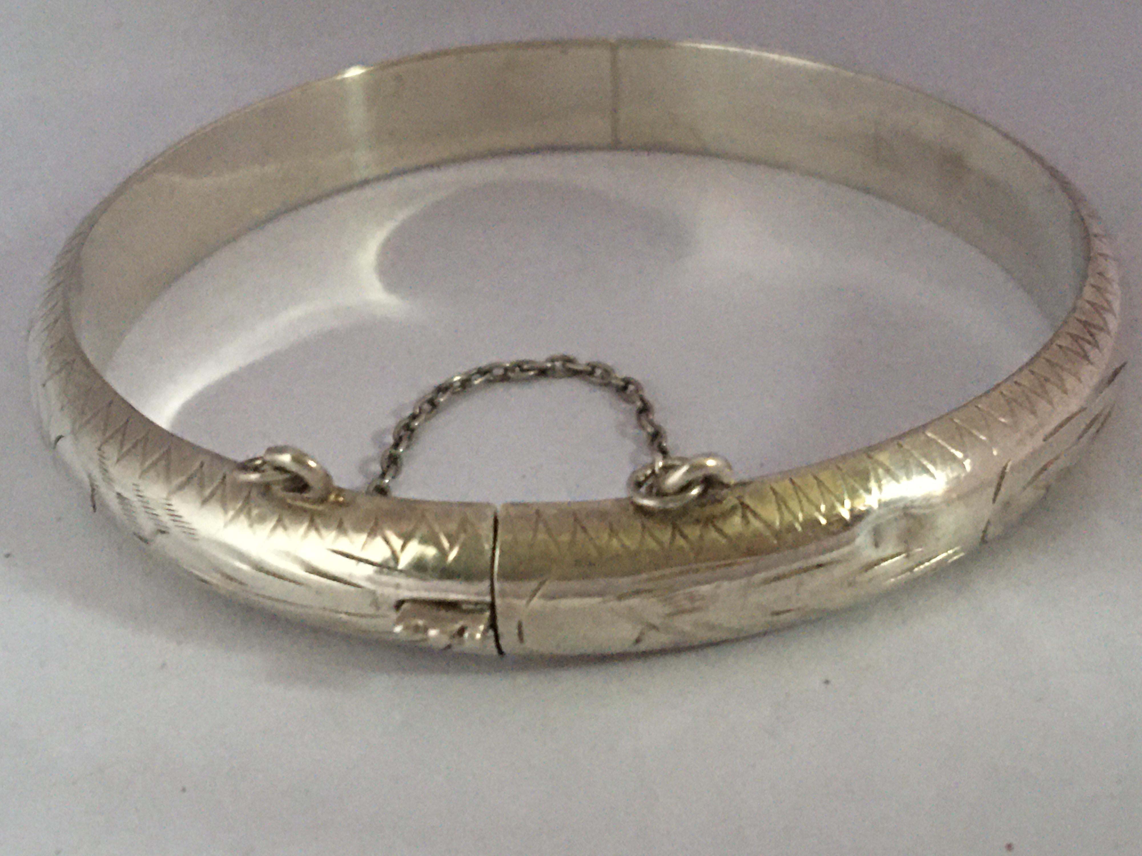 This beautiful pre-owned silver bangle in is good condition visible signs of ageing and wear with light marks on the surface and couple of dents on the outer layer as shown. please study the images carefully as form part of the description.