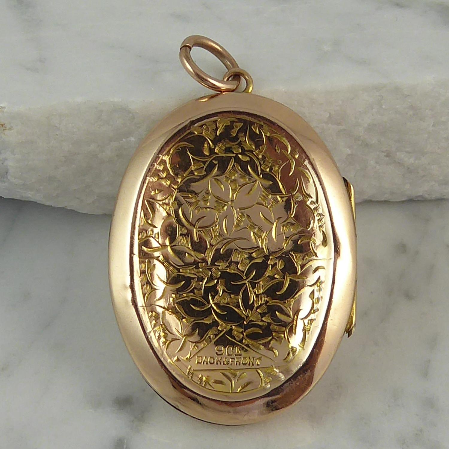 A beautiful little antique locket in 9ct gold back and front.  Oval in shape and decorated to both sides in a foliate hand engraved pattern, the front also having a plain polished, shield-shaped cartouche.  The engraved sections are set in a slight