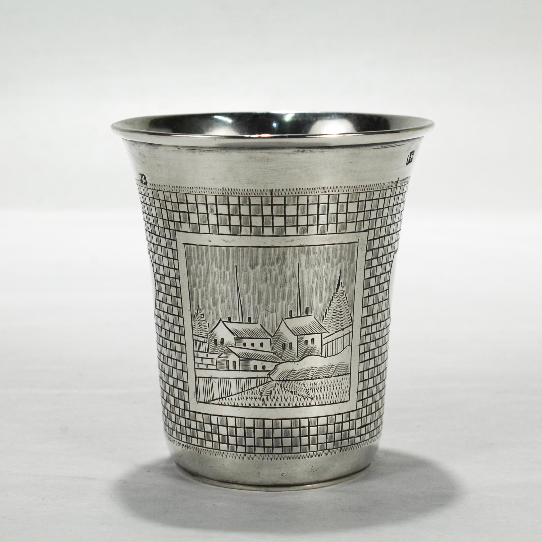 A fine antique Russian vodka or Kiddush cup.

By Mikhail Dimitriyev.

In 84 zolotnik Russian silver (.875 silver).

Decorated with 2 large landscape scenes, 2 shield cartouches, and an etched checkboard ground.

Simply a great Russian silver