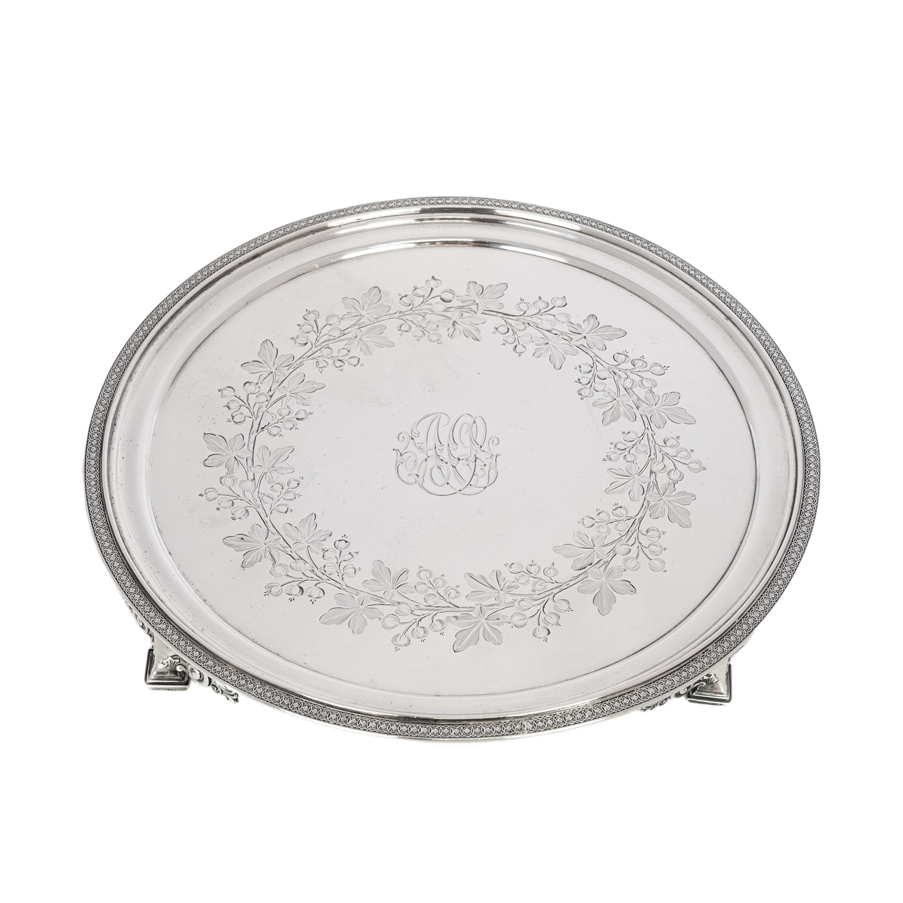 Antique Tiffany & Co footed sterling silver salver or tray, circa 1870.
The circular footed tray is engraved in the aesthetic taste with fruiting flowers and having an 'egg & dart' engraved border to the edge of the tray. Raised on four stepped feet