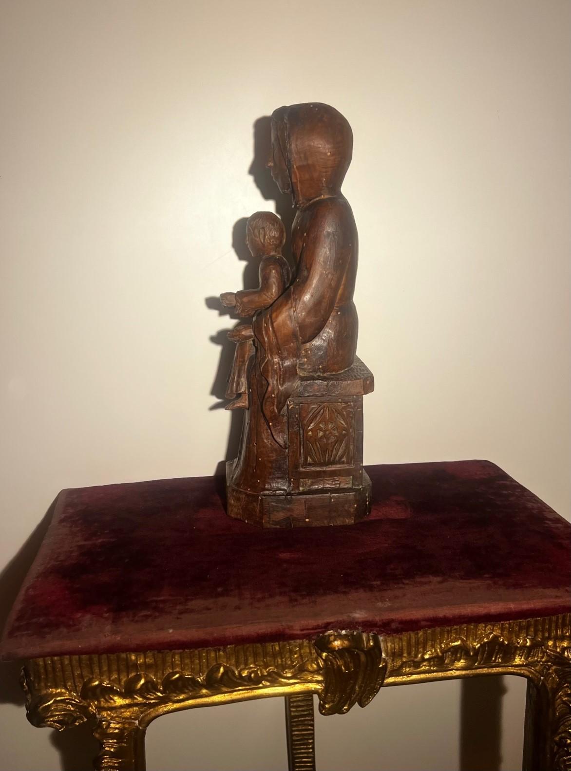 This extraordinary museum piece Enthroned Virgin Mary with the child on her lap comes from the Rhone region in France. The saint symbol and protector of France, this statue of Madonna was found with a Tabernacle ( the interio fabric/ velvet has been