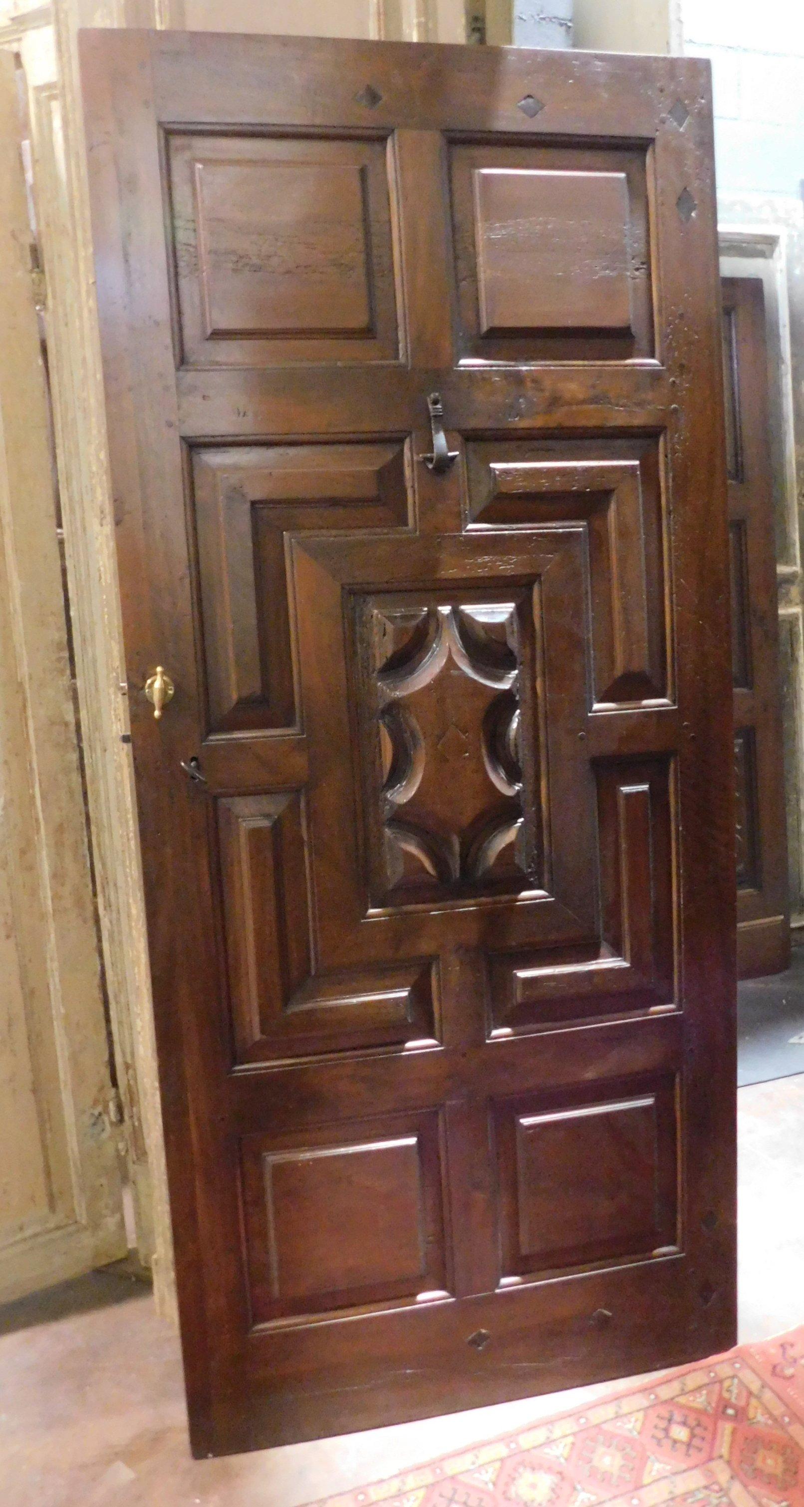 Ancient entrance door, main entrance, very rich door in precious walnut carved completely by hand, baroque motifs with deep and very rich molure, built for church in northern Italy, early 18th century. Complete with original irons and front clapper,