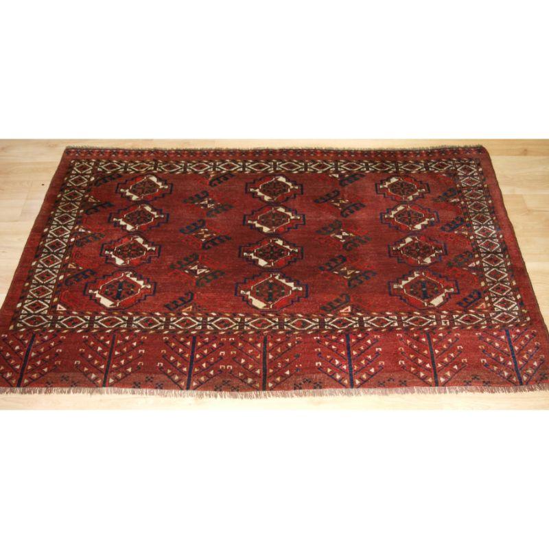 Antique Ersari Turkmen 12 gul chuval with good colour. The elem design is the Turkmen tree design. The chuval has a rich rust red colour and very soft wool.

This would be an excellent hearth rug, the colours are very warm.

Slight even wear