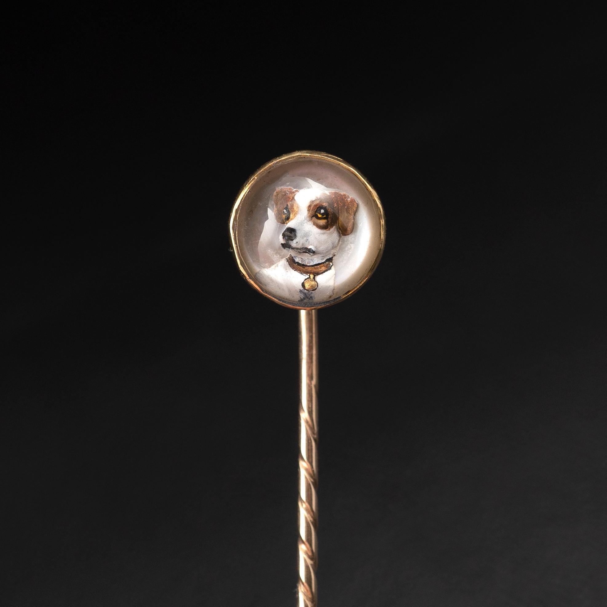 A delightful antique Essex Crystal stick pin with dog portrait, made in 15 karat gold, complete with original antique box, Circa 1900.

The highly collectible pin displays a Jack Russell Terrier dog which appears three-dimensional inside a crystal
