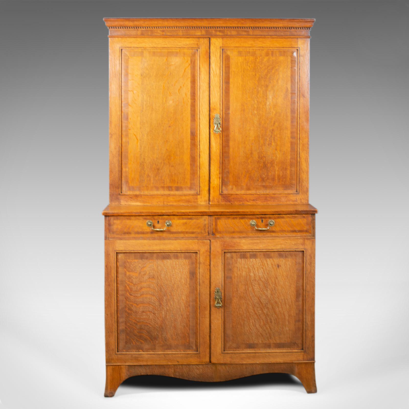 This is an antique estate cabinet. An English, Victorian, oak press cupboard dating to the late 19th century, circa 1890.

Attractive honey tones to the English oak 
Grain interest and a good consistent colour
Desirable aged patina in the wax