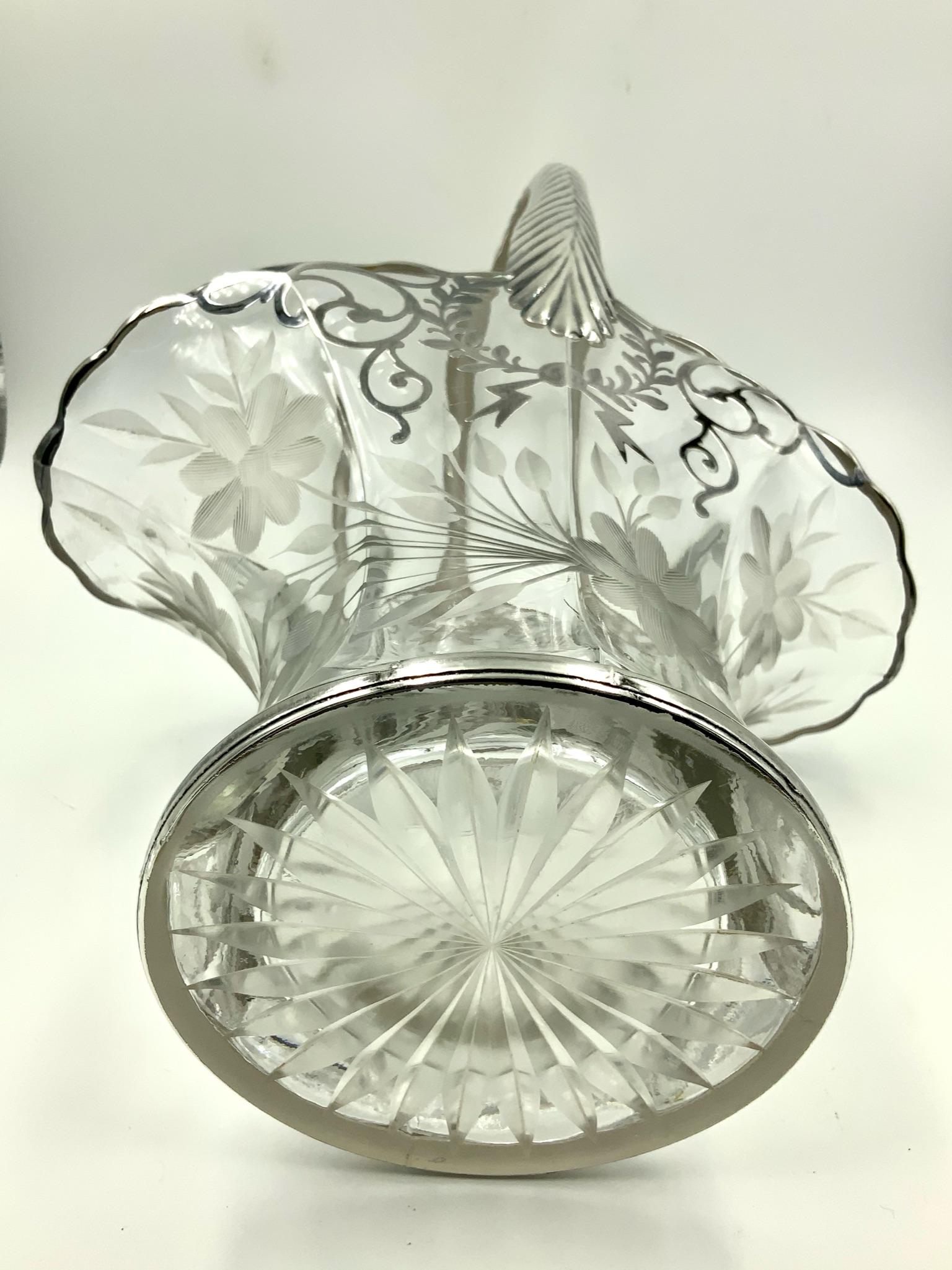 Incredible early 20th century floral wedding basket featuring an etched floral design on the bottom area and a garland scroll sterling silver overlay design on the top part. It is completed by a highly stylized sterling overlay handle. A truly