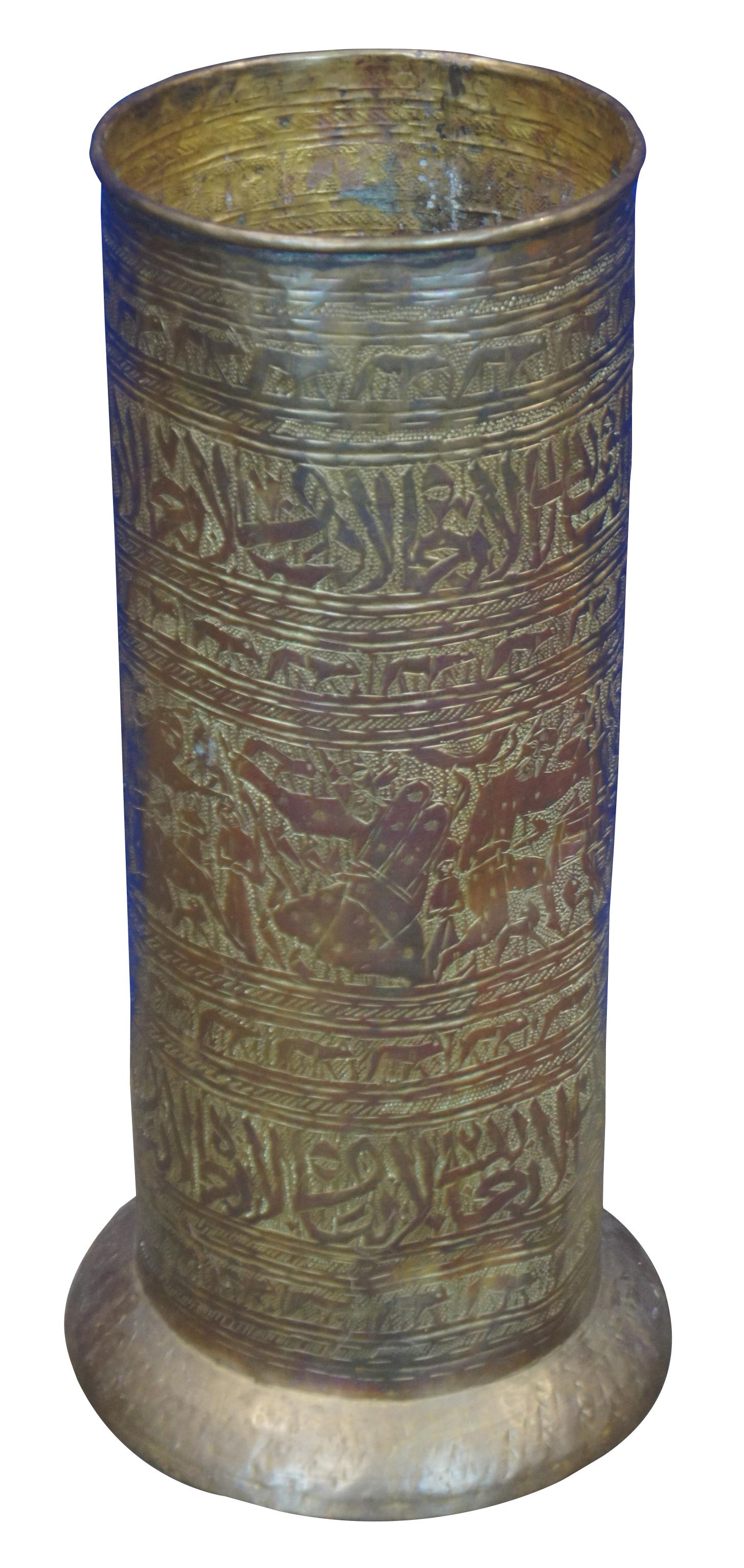 Antique brass umbrella or cane stand etched with Byzantine / Orthodox Christian motifs and figures including a cynocephalus (dog headed) Saint Christopher and Moses with horns holding the Ten Commandments, among other saintly figures dwarfing other