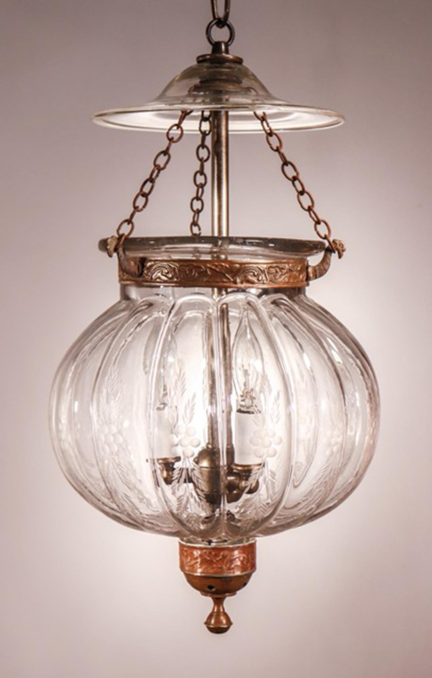 An antique Belgian melon or pumpkin-shaped bell jar lantern with an etched wheat motif, circa 1900. This authentic lantern features excellent quality hand blown glass and an ornamental brass band and finial/candle holder base. The fixture has been