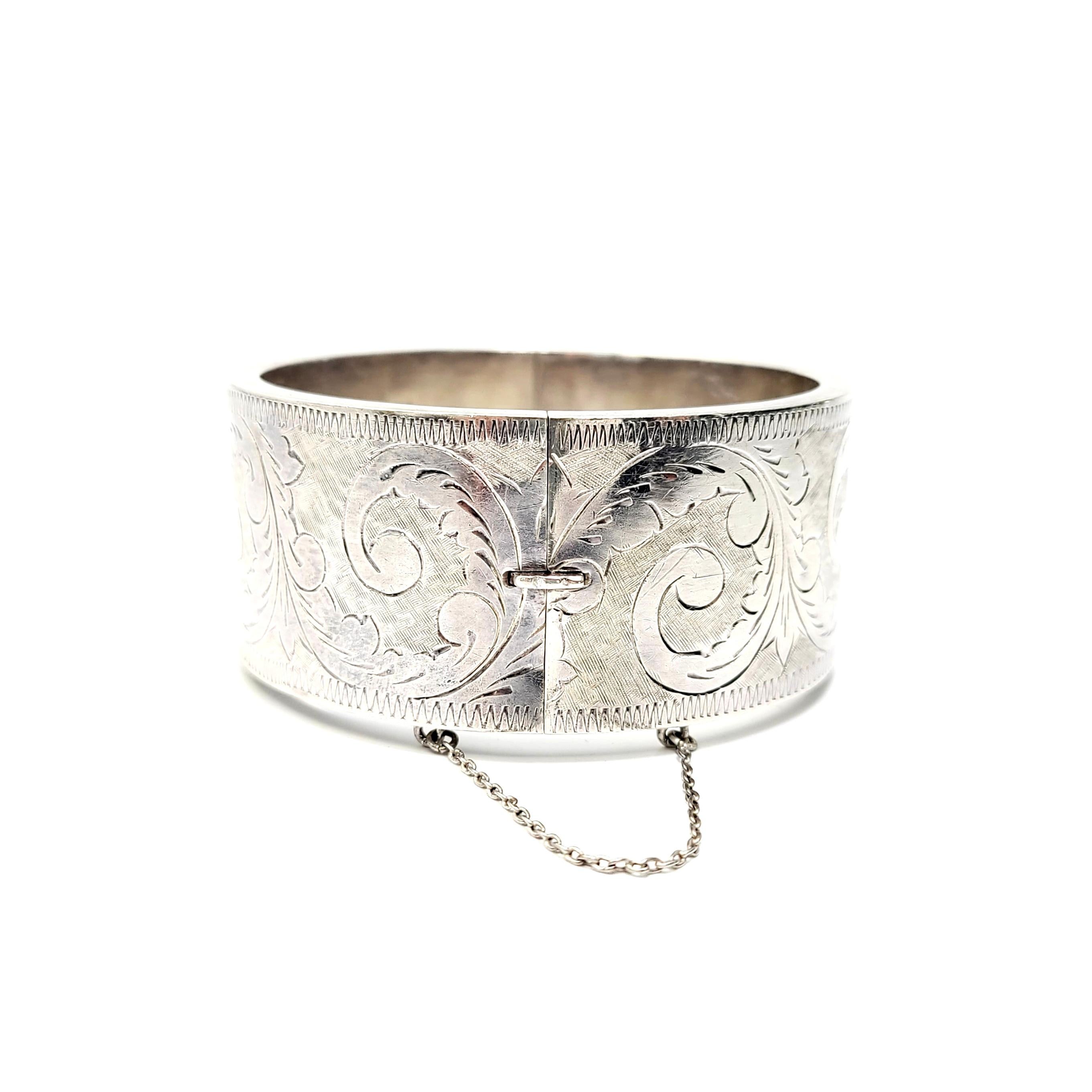 Antique sterling silver etched bangle bracelet.

Beautifully etched swirl and berry design all around the bracelet.

Measures approx 1 3/16