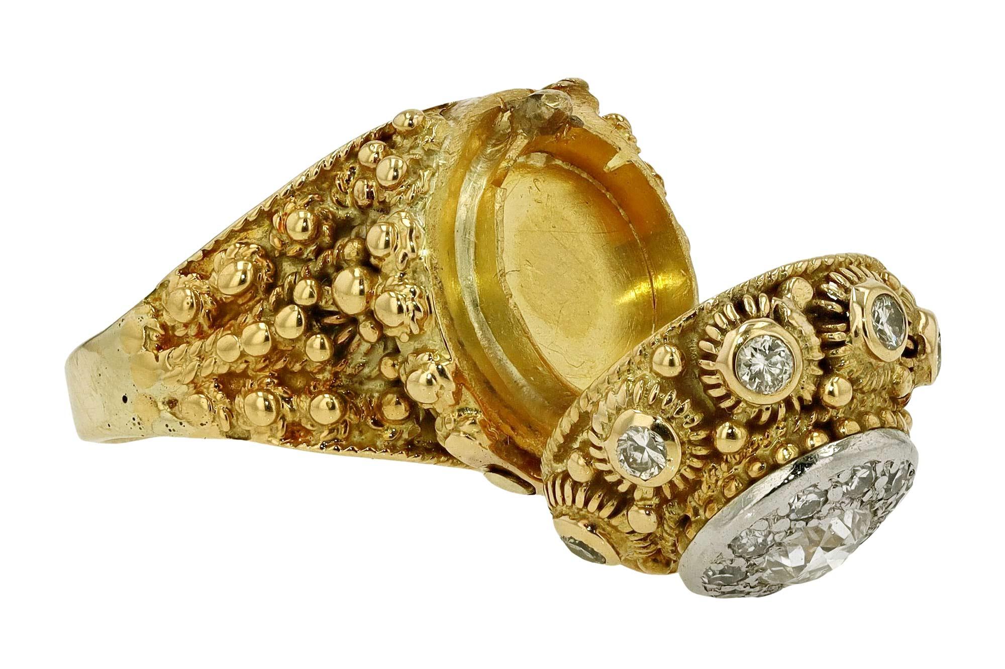 A brilliant and unique Etruscan Revival poison ring from the Victorian era. Made of 18 karat yellow gold with a prominent and stately design, featuring detailed beading and granulation, including an ingenious disguised vessel. Centered by a gleaming