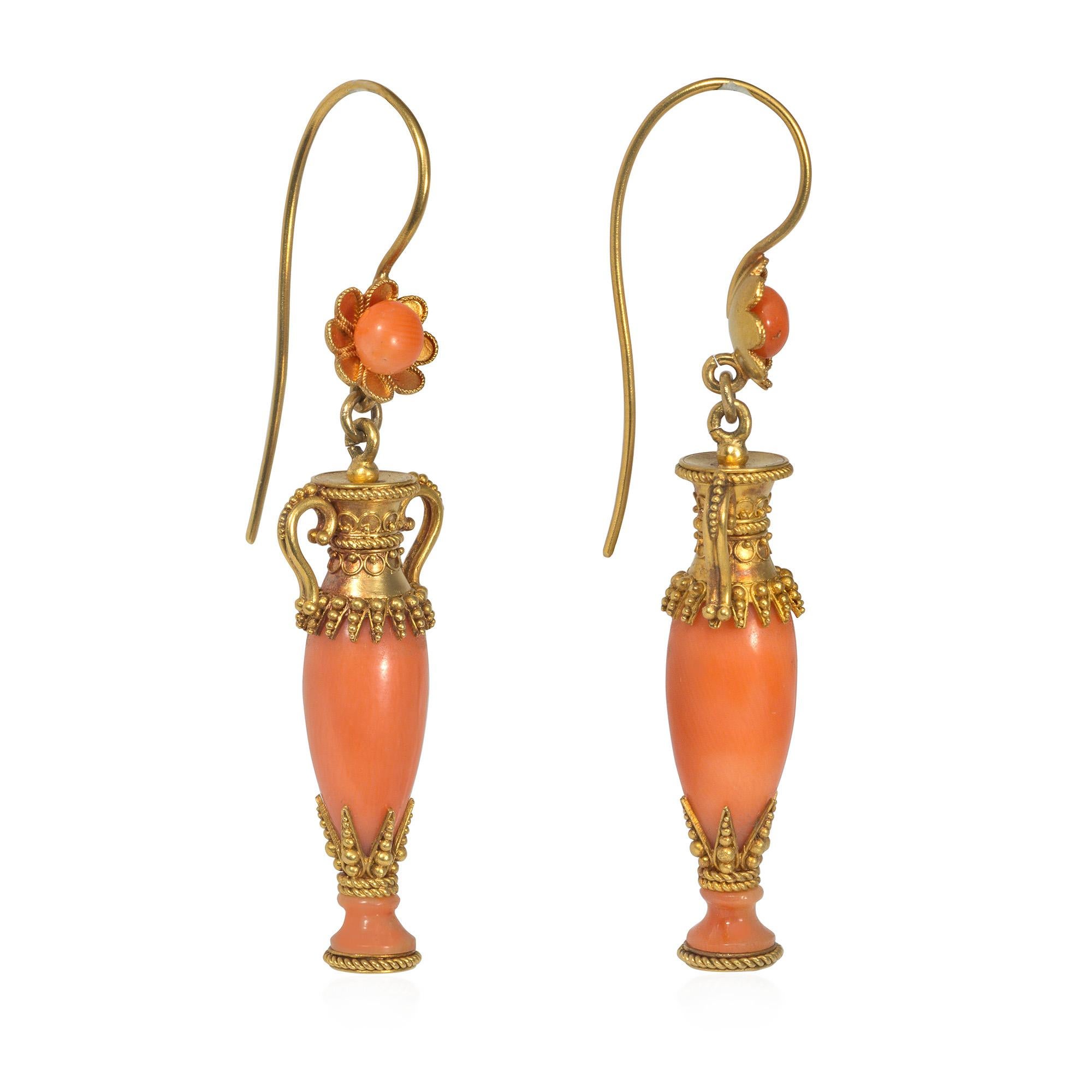 A pair of antique Victorian period gold and coral earrings in the Etruscan style, designed as coral amphorae with applied wire work and granulation, suspending from gold florette surmounts inset with coral beads, in 18k.

Coral, one of the few