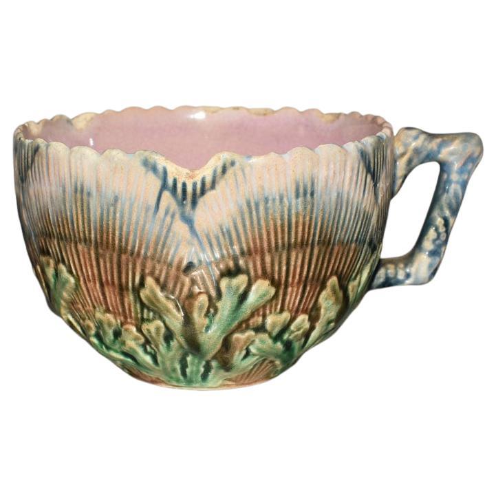 Created in the late 1870s, this highly collected Griffin Smith & Hill Etruscan tea cup and saucer will be a fabulous addition to a current collection. The exterior of the cup and plate is decorated in a textured seaweed and shell design and then