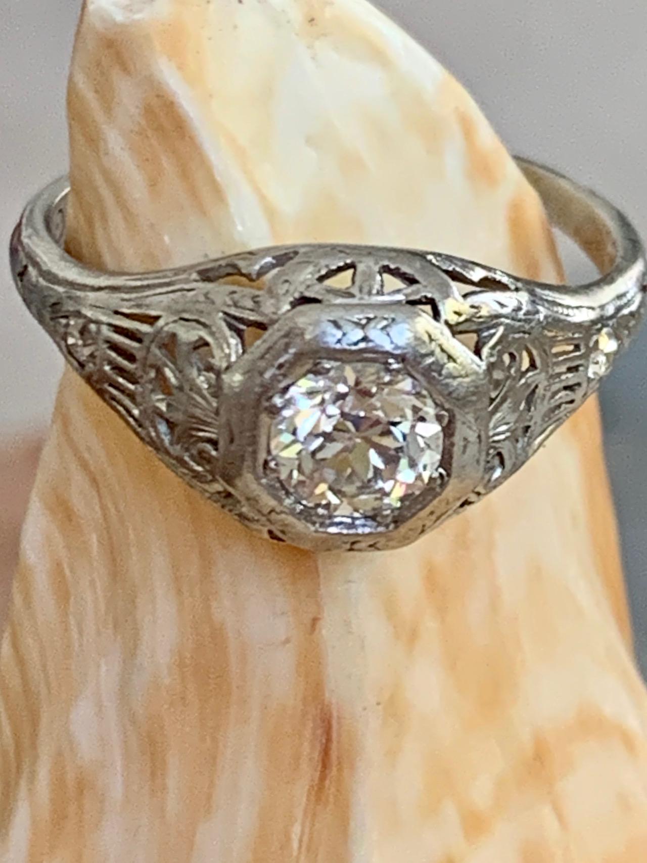 This antique ring features a .50 carat Euro cut Diamond as the center stone.  It is surrounded by two-.02ct single cut Diamonds.

Size: 5 1/2 - this ring is resizable but vendor does not offer sizing services. 
Weight: 2.7 grams
Average Grades: