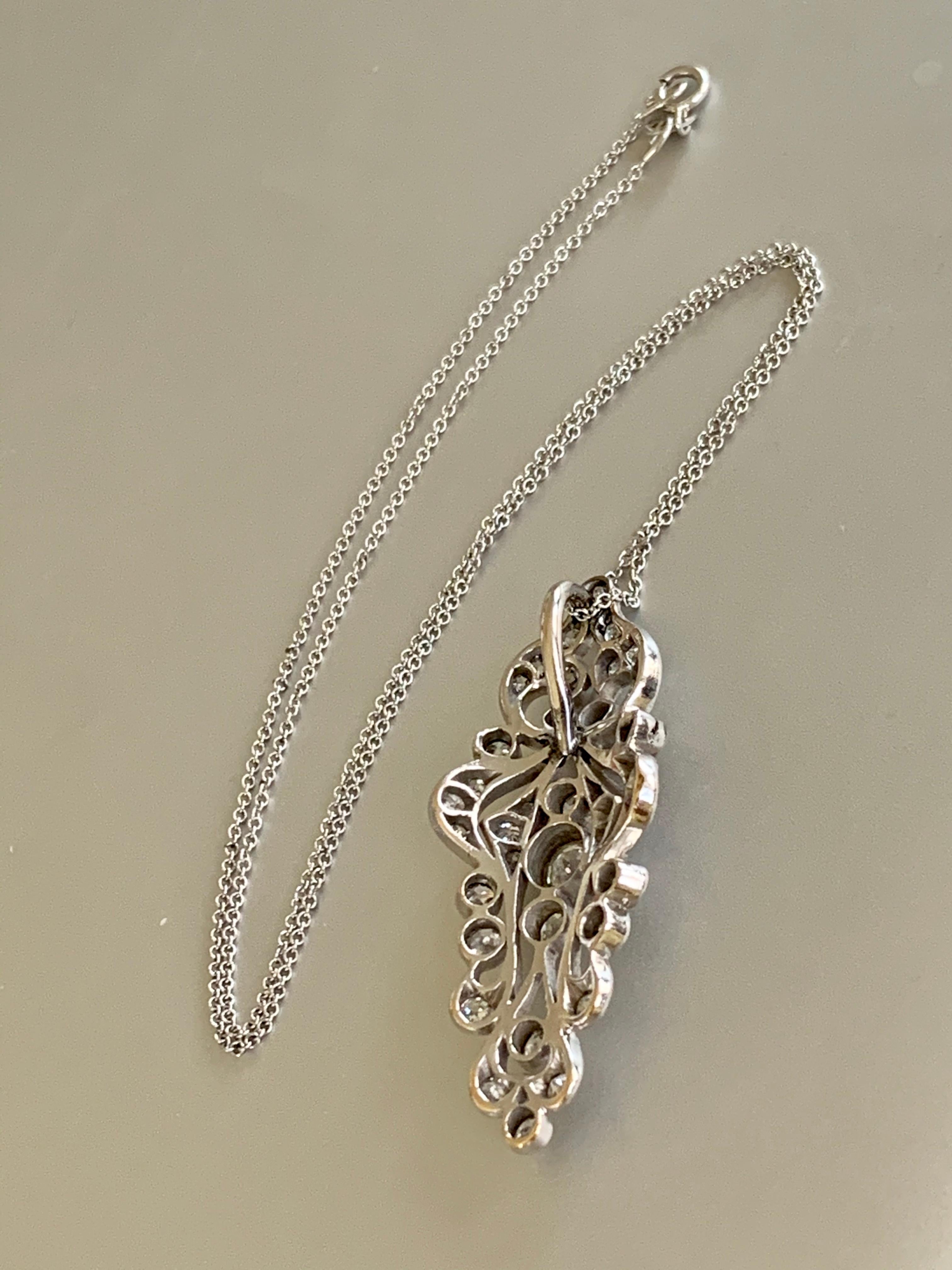 What an amazing pendant.  It features European cut Diamonds totaling 1.5ctw.  Grades are estimated average of SI-H. 

The pendant is Platinum and the chain is 14 karat white Gold.  The chain is 15