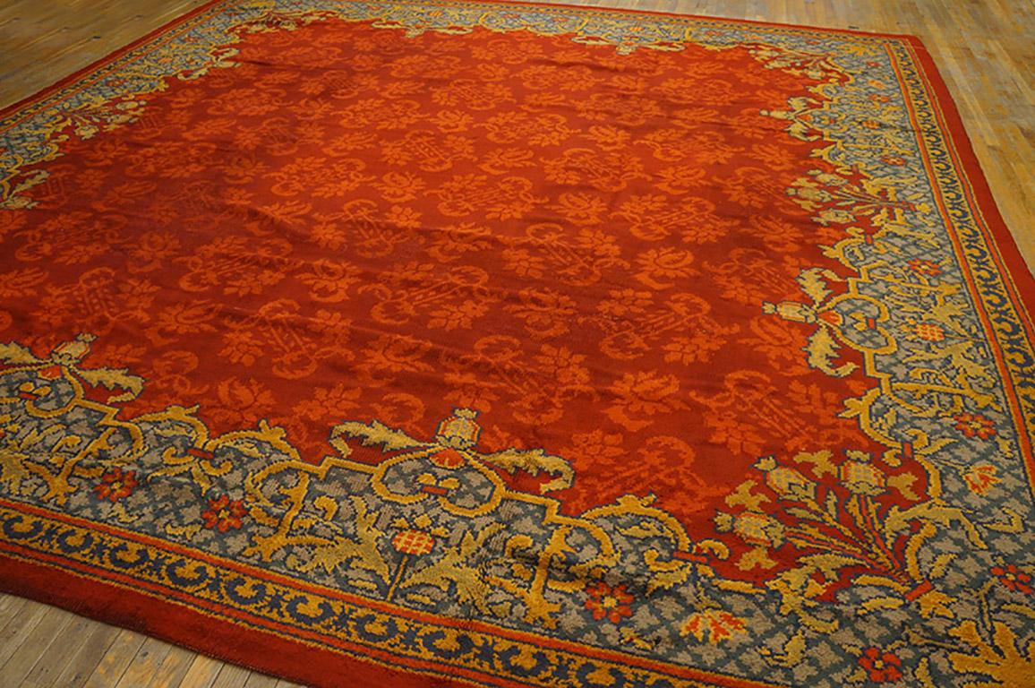 The brilliant orange-red of this very late Victorian carpet - Early Edwardian displays floral sprays in lighter orange with a lacy, broken border with poppies in the corners and centering two sides. The design looks like a velvet textile. Just the