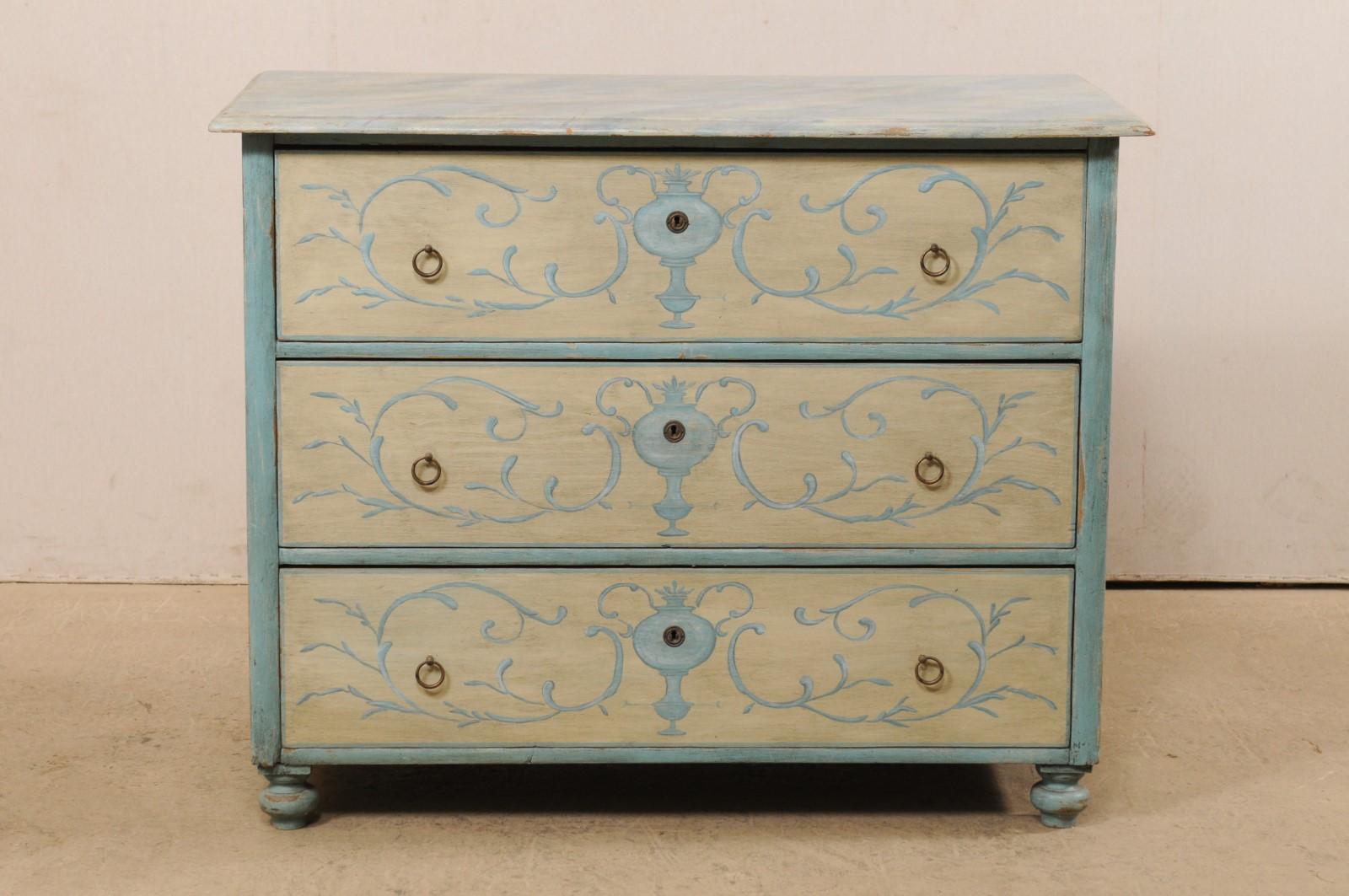 A European faux-marble and neoclassical-inspired motif hand painted wood chest from the turn of the century (late 19th to early 20th century). This antique chest from Europe features a rectangular-shaped top with beveled edges, atop a case housing