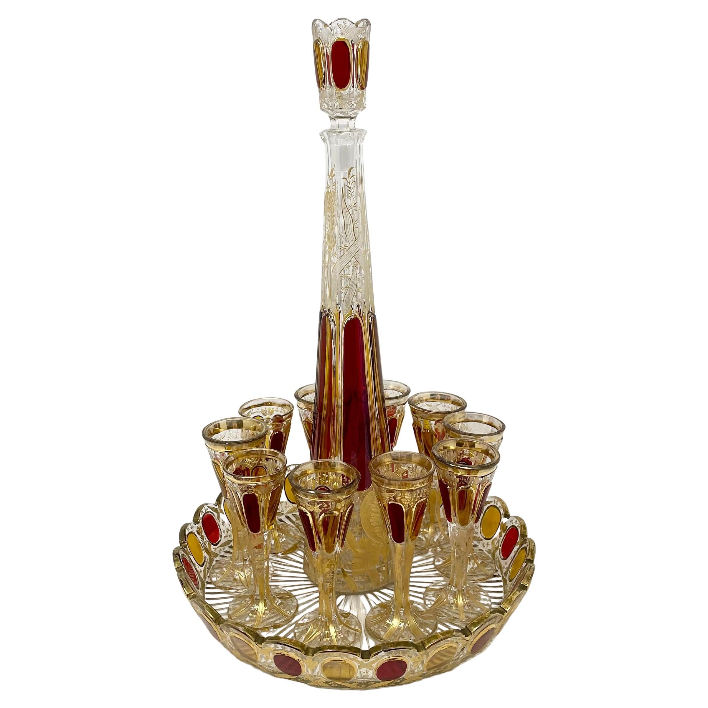 Antique European cut crystal & ruby glass decanter with 10 cordial glasses and tray, circa 1920's.
1 Decanter with Stopper:
14 1/4