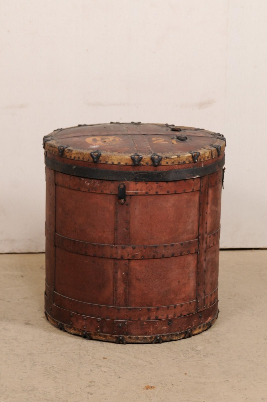 A European drum-shaped storage container with lid top from the early 20th century. This antique storage vessel from Europe stands approximately 29.25