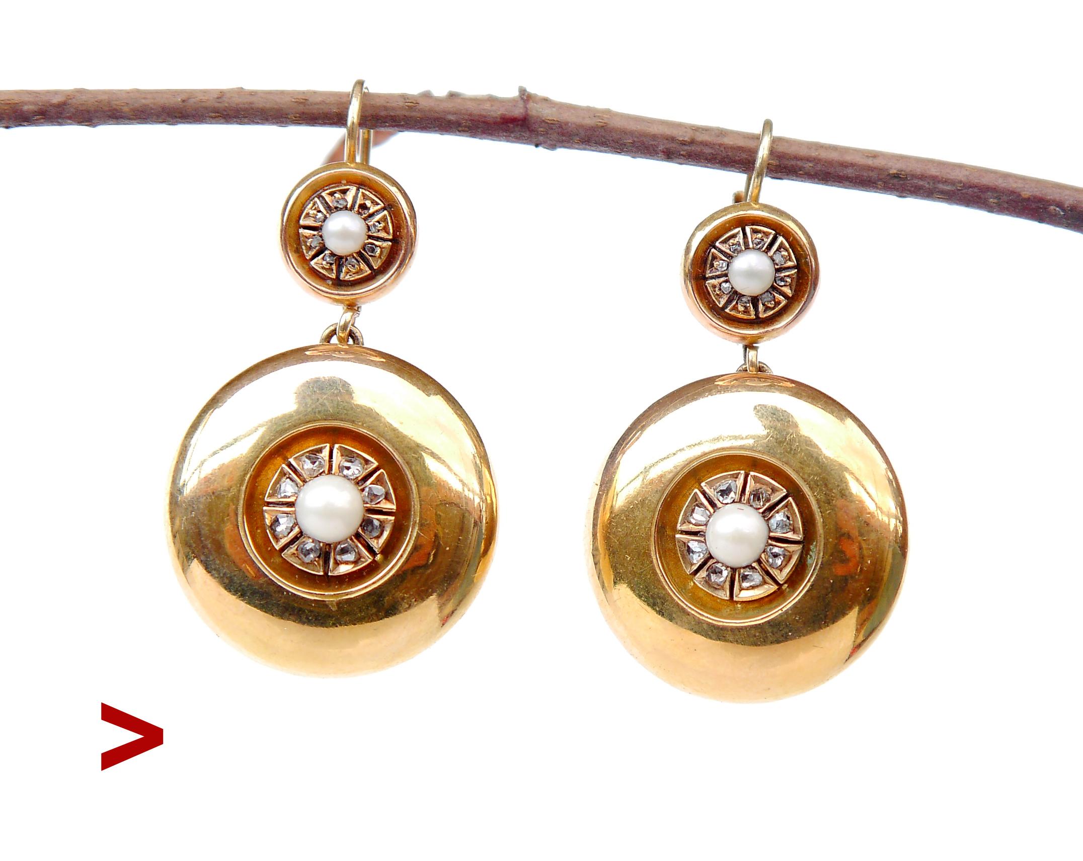 A pair of antique earrings with hollow round bodies in solid 14K Yellow Gold decorated with natural river half - Pearls and rose- cut Diamonds.

This pair dates from Europe, made in the early 1900s. No hallmarks on both, the metal was tested 14K