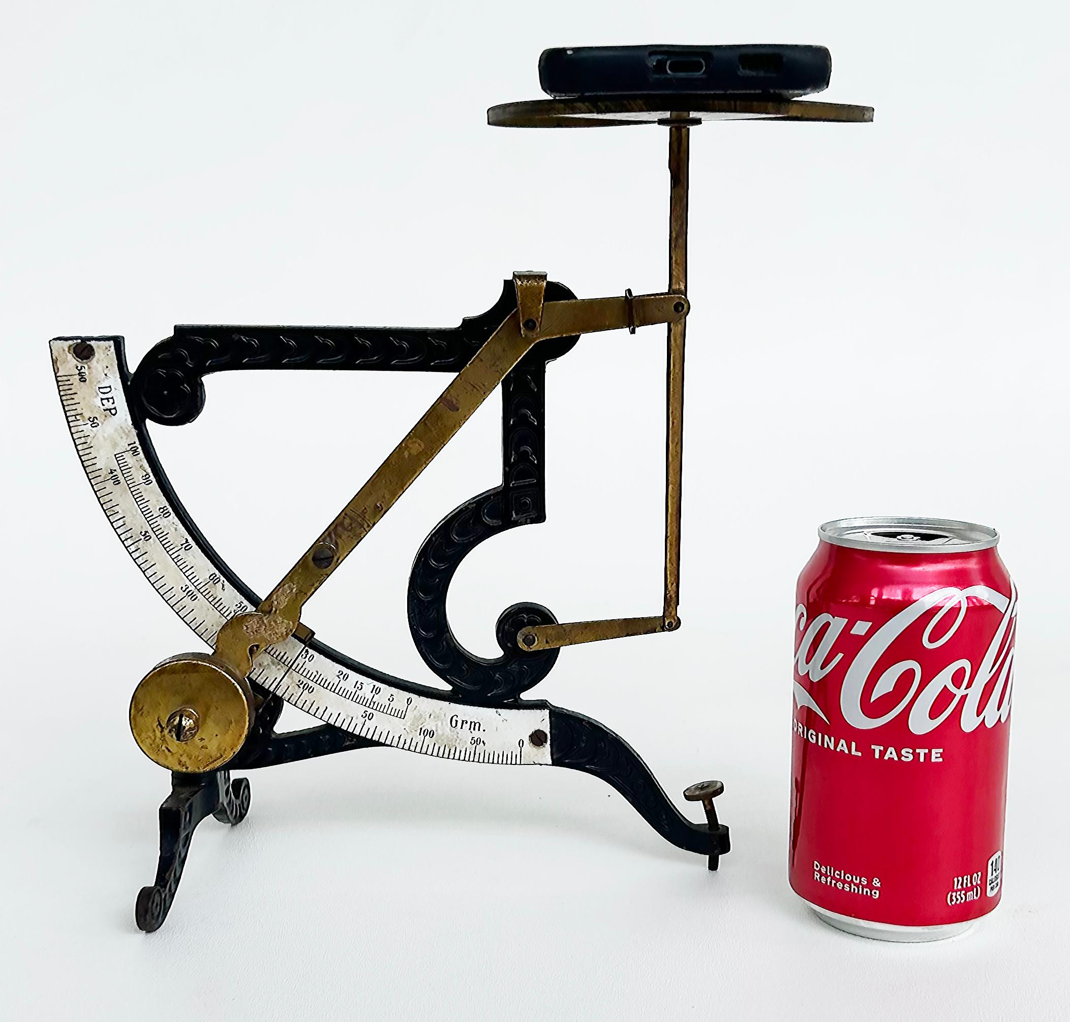 Antique European Enameled Postal Scale with Brass, this desk top pendulum scale is a quirky and fun addition to your collection of antique scales. Bought from a collector, it’s made of black iron, white enamel, red metal, and brass with a stunning