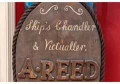 Antiguo letrero de tienda náutica de arte popular europeo pintado y tallado