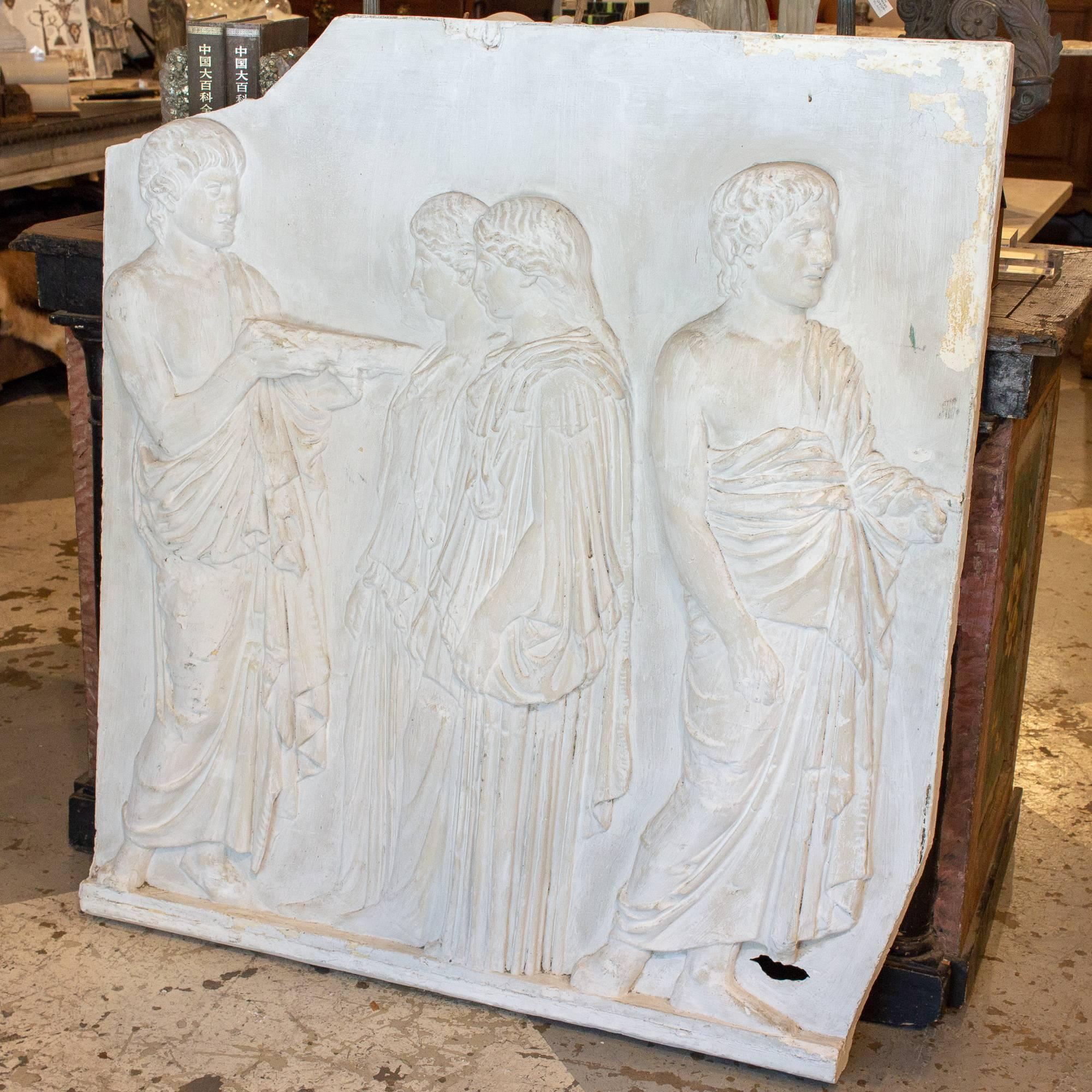 Uncovered in Belgium, this 1940s plaster wall plaque has a very Classical Greek subject matter, showing four figures in flowing robes, two of which appear to be men and two women. This piece would look beautiful mounted on a wall or simply leaning
