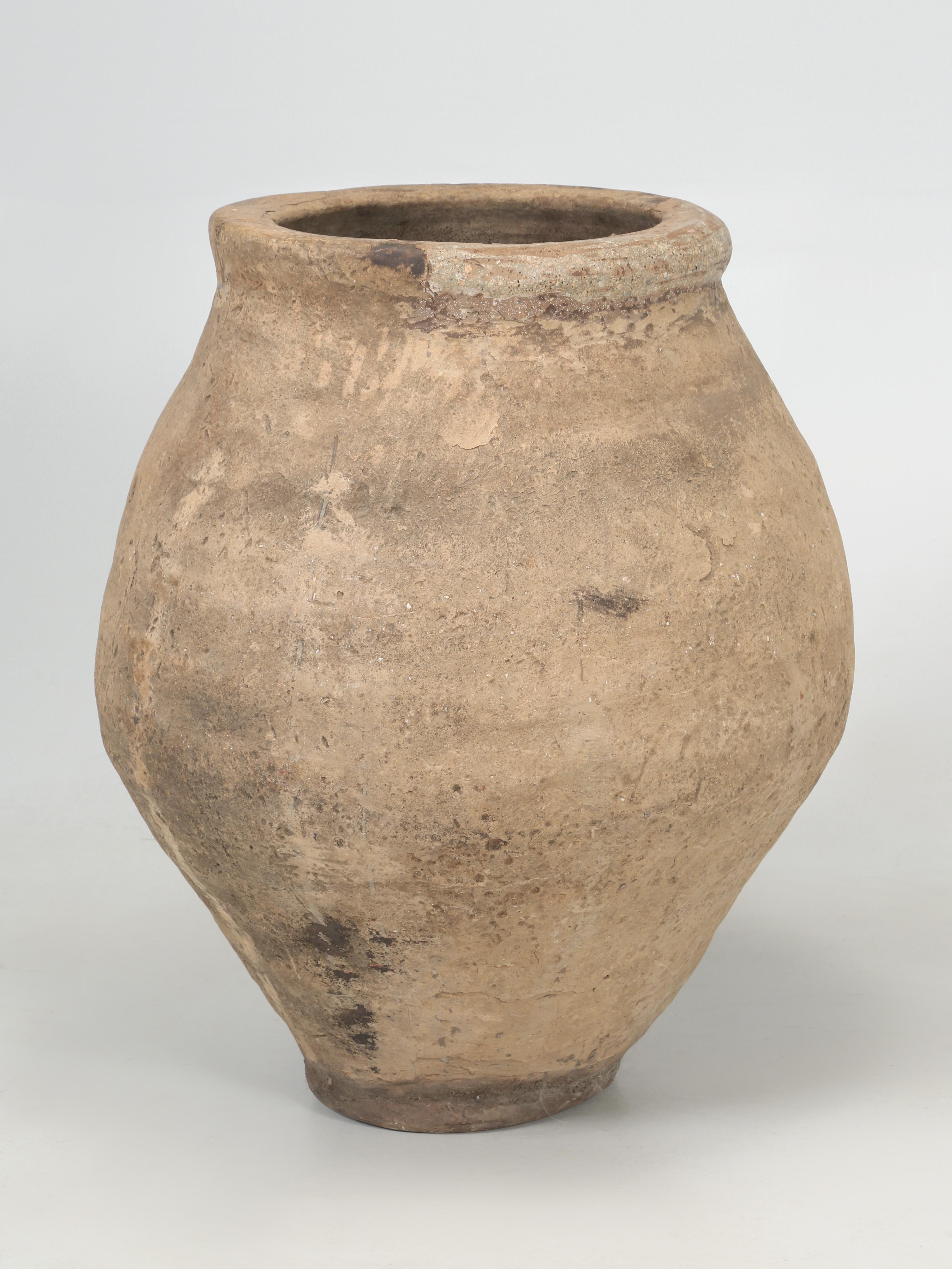 Antique clay pot, planter, or urn, which we would normally describe as terra-cotta, but we are not 100% positive our large planter is actually terra-cotta. The planter/urn is made from a clay that had quite a bit of small rock with the clay and