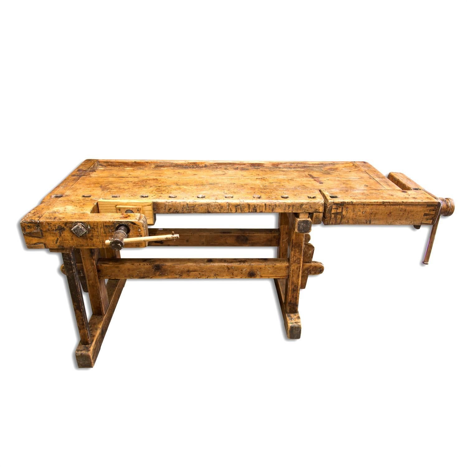 Antique European carpenters' workbench with very nice patina, madein the 1920s in Central Europe. It´s made of oakwood. It features two wooden vices with wood handle. It has been restored and waxed using a beeswax. These workbenches are usually used