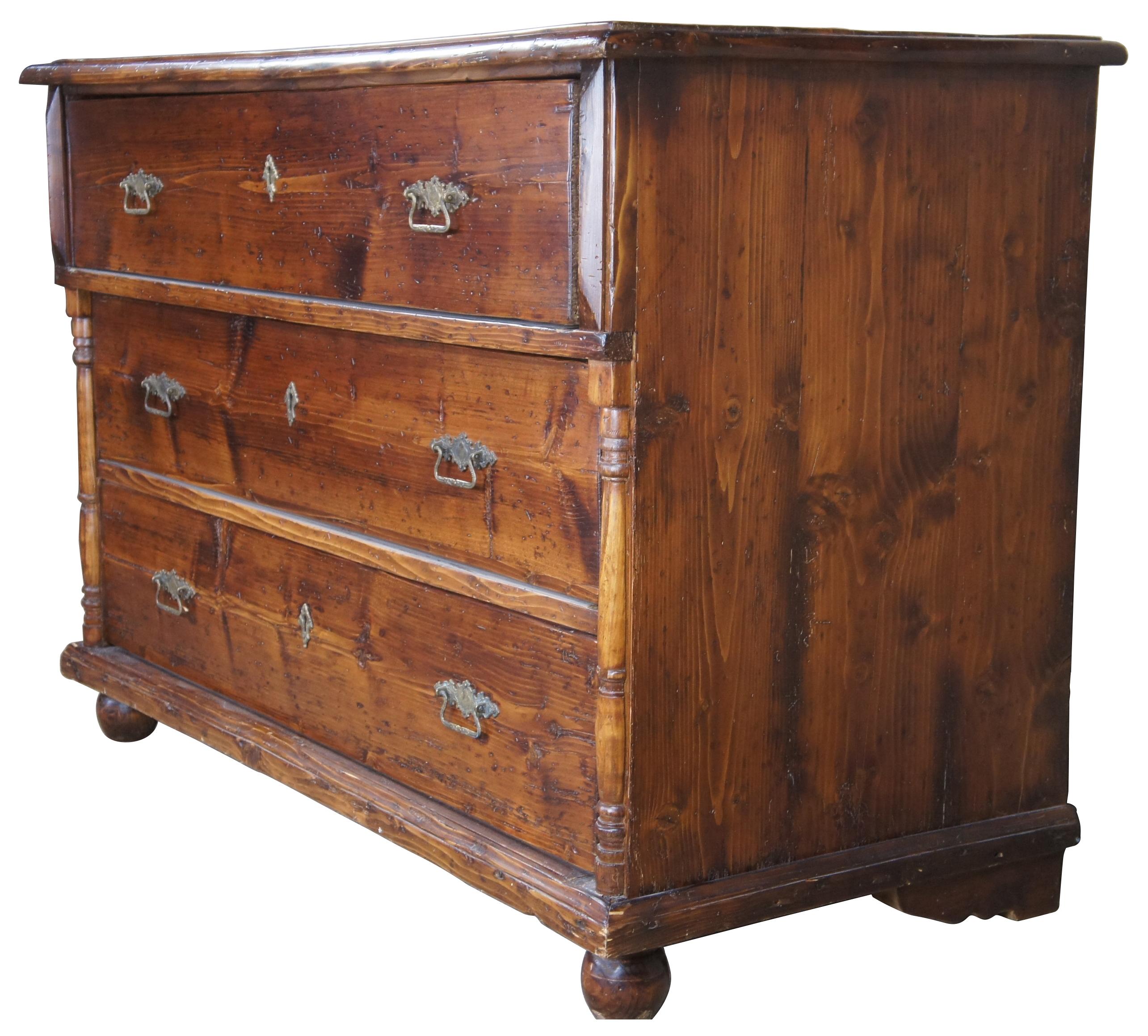 Early 20th century pine chest or dresser. Made of pine, featuring three drawers and half turned baluster mounts over bune feet. Naturally distressed with brass hardware. Measure: 53