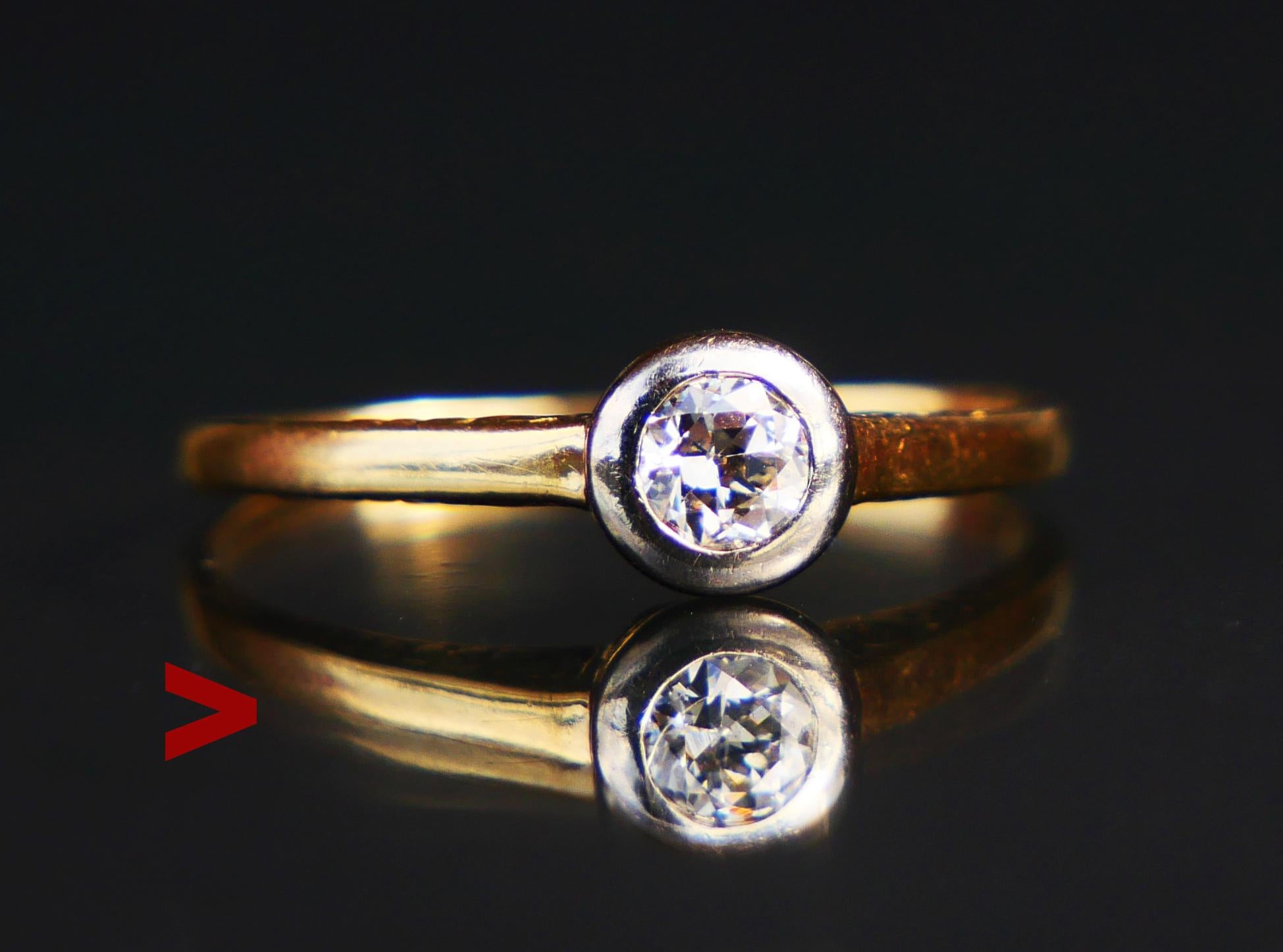 Fine Antique Ring made in Europe, ca. 1920s.

Solid 14K Yellow Gold band, carved ornaments on the shoulders. Old European cut Diamond in White Gold bezel measures Ø 4 mm x 2.2 mm deep / about 0.25 ct. Color ca H,I / SI. Stone's backside is open. The