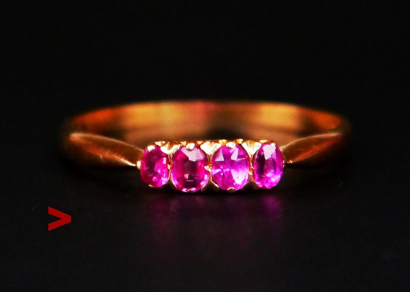 Antique Ring featuring, band in 18K Yellow Gold, 4 natural pinky red rubies, made ca.1900 s -1930s.

Hallmarked 18 ct. No hallmarks of the maker.

The crown part with stones is 10 mm wide. Two central stones 3 mm x 2.55 mm /0.15 ct each, 2 on flanks
