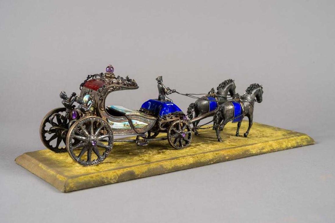 European silver and enamel horses with carriage. Depicting a coachmen and two horses, having GuillochŽ and Viennese enamel on sterling silver with gem stones decorated areas, on a velvet covered base. Dimensions: Height 7.5