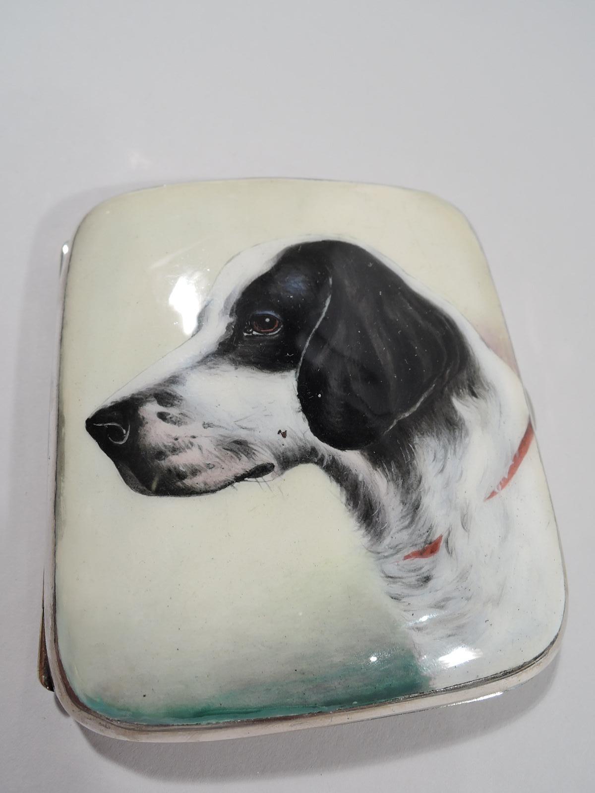 European 800 silver and enamel cigarette case, ca 1910. Rectangular with curved corners and hinged cover. On cover is a bust of a spaniel with nuanced black and white fur with embedded red collar, pinkish nuzzle, and intent brown eye. A sensitive