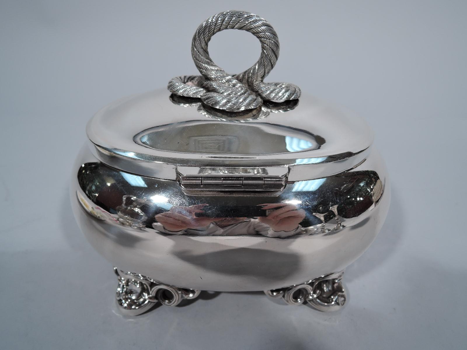 European 750 silver box, ca 1880. Ovoid with 4 scrolled supports. Cover hinged with floral tab and cast rope finial. Interior gilt. Marked. Weight: 11 troy ounces.