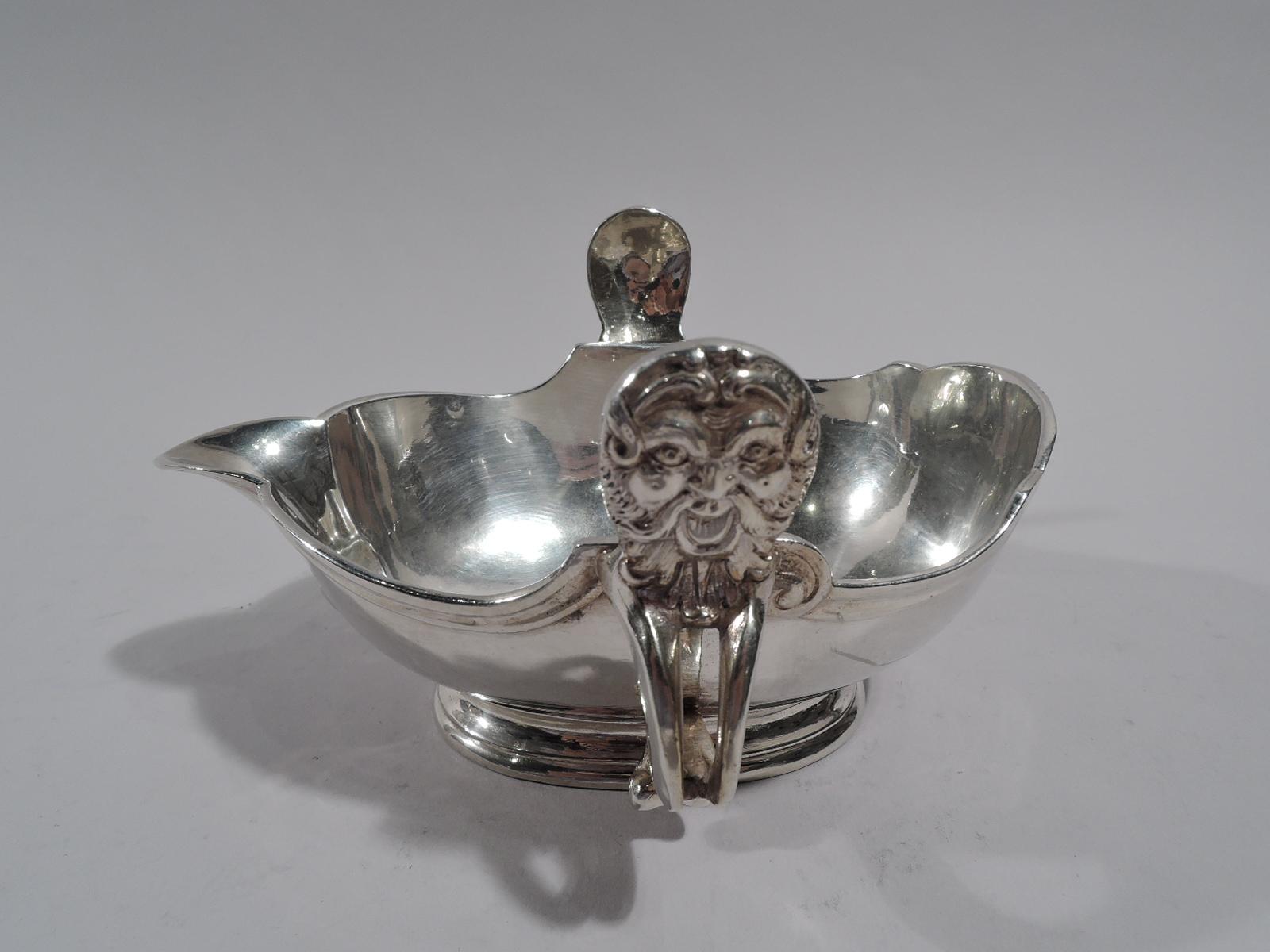 European silver sauce boat, circa 1900. Ovoid with fluted v-spout and scrolled monopodia side handles with lion heads. Molded curvilinear rim. Stepped oval foot. A nice revival piece in the 18th century style. Mark and pseudo-marks.

Overall