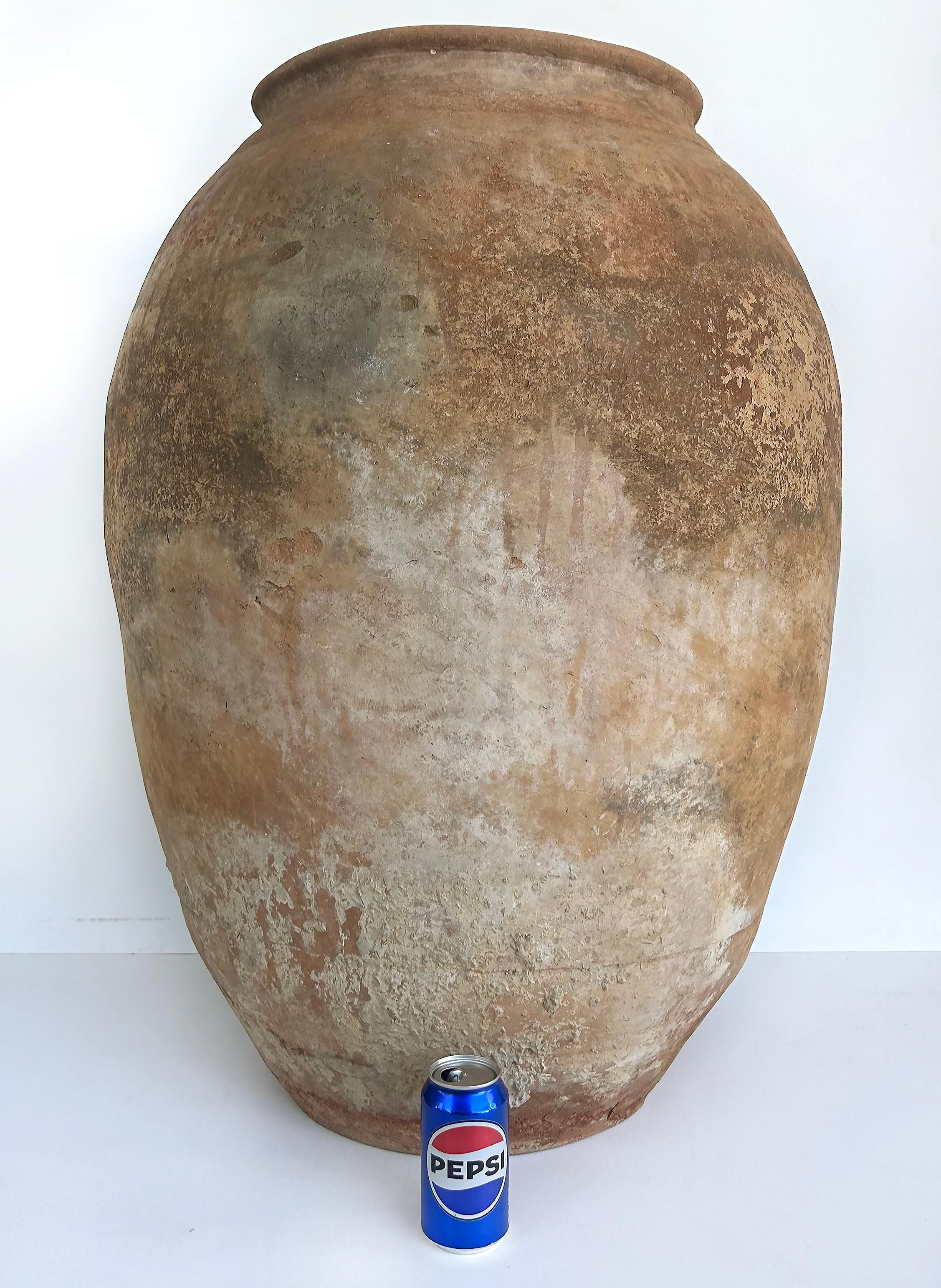 Antique European Terracotta Olive Jar Planter Urn

Offered for sale is a lovely antique terracotta olive jar. The vessel is large and has a wondaful aged antique patina. This is a great statement piece for interior or exterior use. The top rim edge