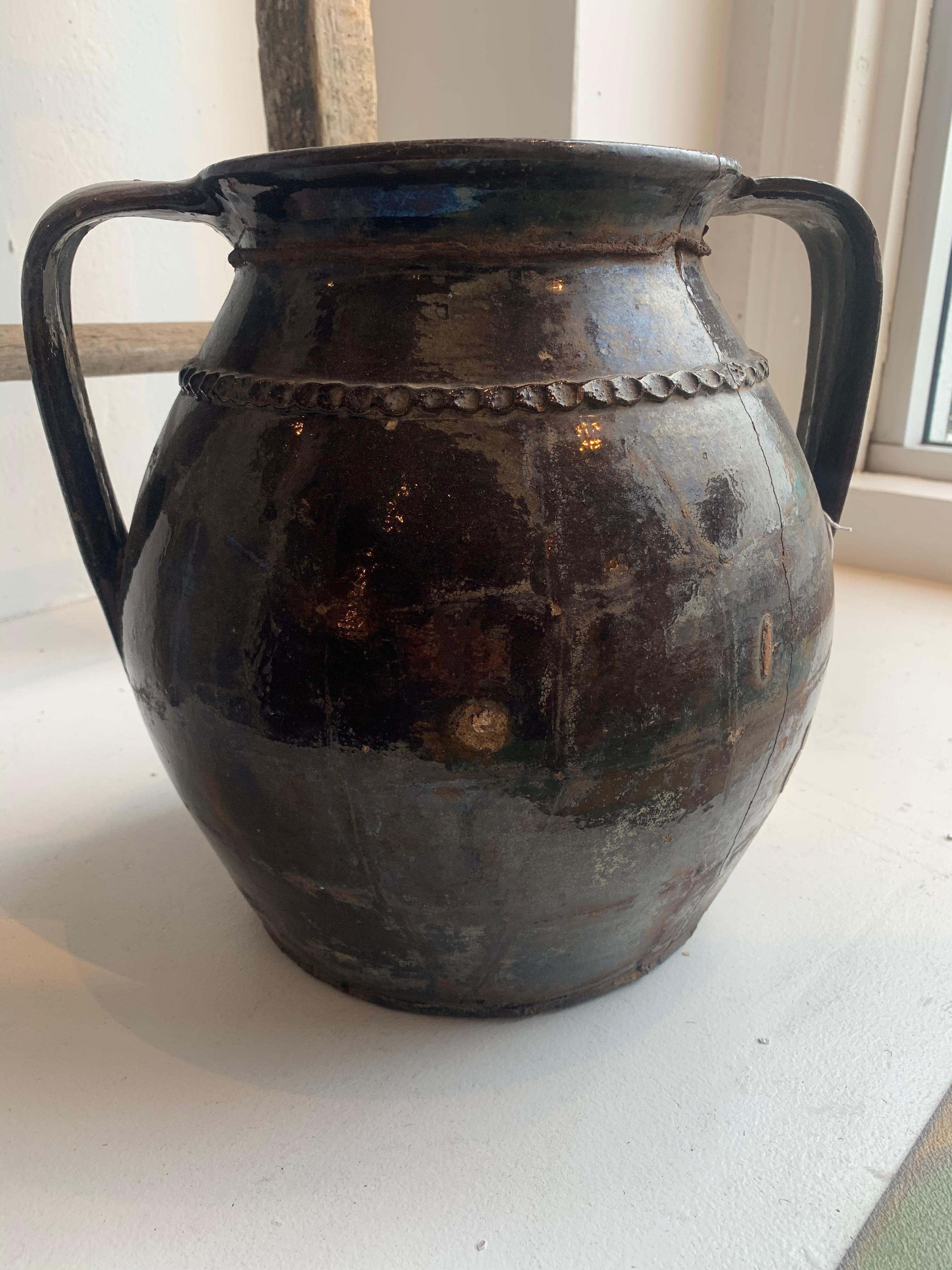 Offered is a antique brown ceramic vase. This vase has a beautiful patina to the glaze with minor chipping giving it the perfect aged look.
  