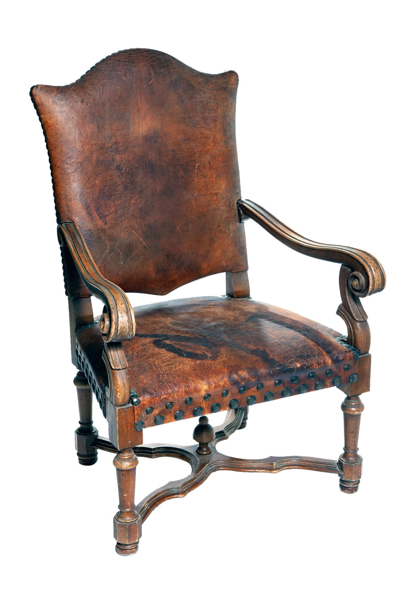 A gentleman's occasional European leather armchair with leather seat & back adorned with oversized antique brass studs/nailheads.Perfect for the library and or study. Comfortable & sturdy. There is a stain on the leather seat, see images for