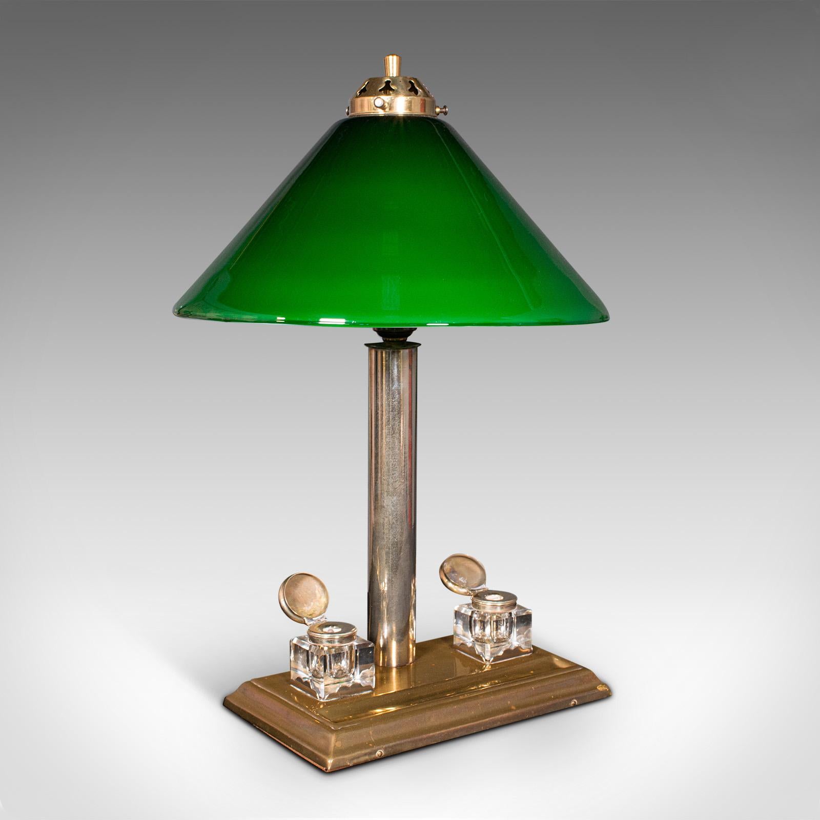 This is an antique executive desk lamp. An English, brass and glass table light with ink wells, dating to the Edwardian period, circa 1910.

Wonderfully decorative desktop lamp, with a useful base
Displays a desirable aged patina and in good