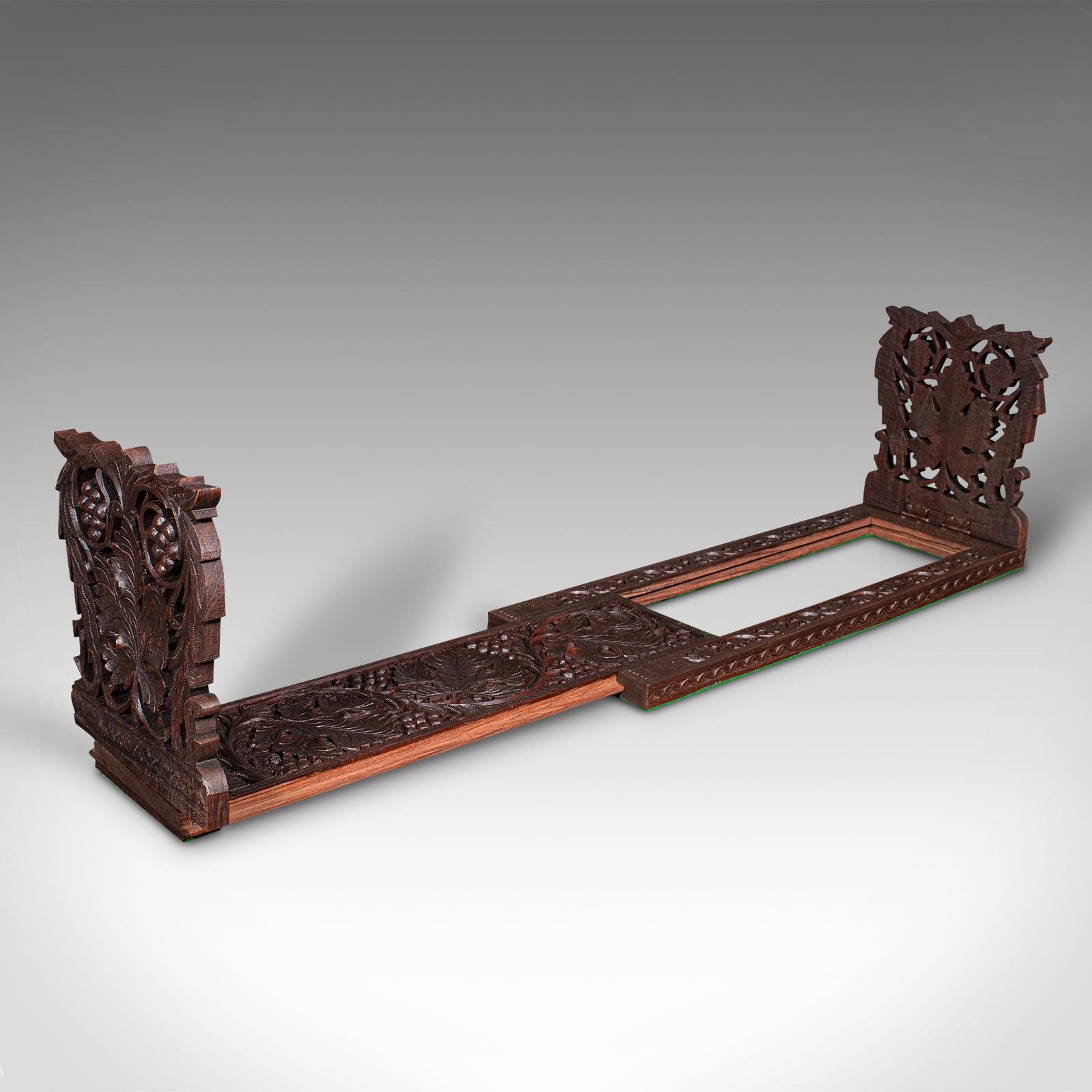 
This is an antique extending book slide. An Anglo-Indian, carved teak novel rest, dating to the late Victorian period, circa 1900.

Pleasingly decorative ends and extending to a generous width
Displays a desirable aged patina and in good order
Teak