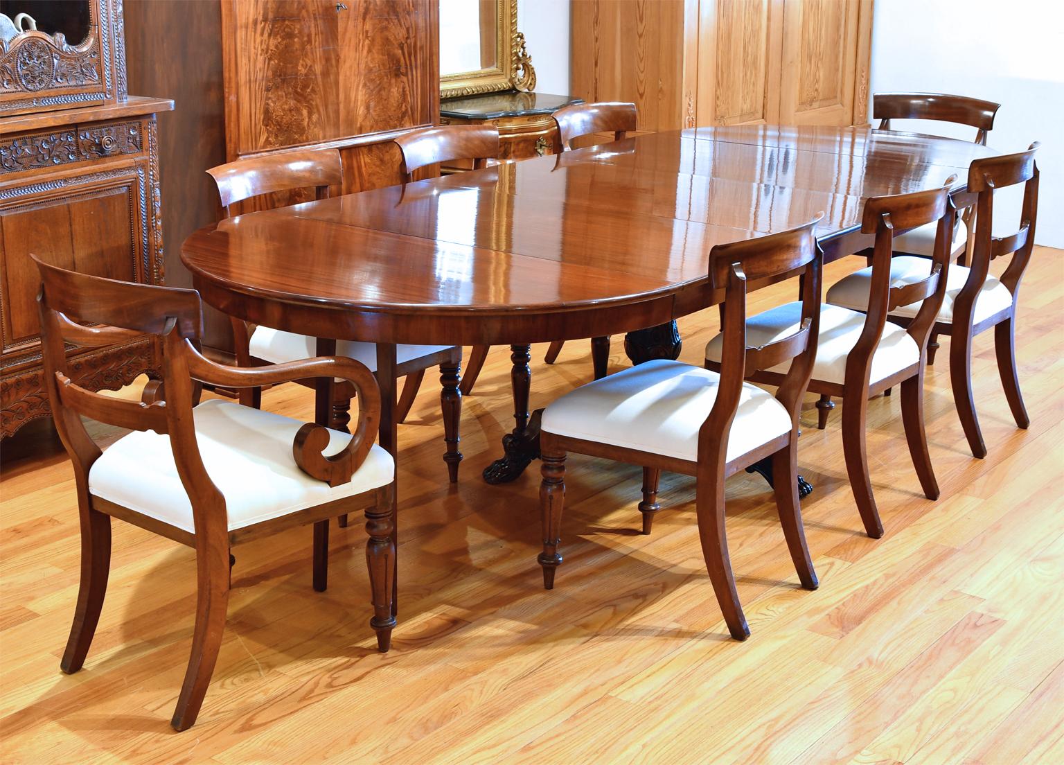 A very lovely Christian VIII round pedestal dining table in fine West Indies mahogany with 5 extension leaves. Skirted round top rests on center pedestal featuring a baluster-turned column with acanthus carvings over a tripod base that ends in