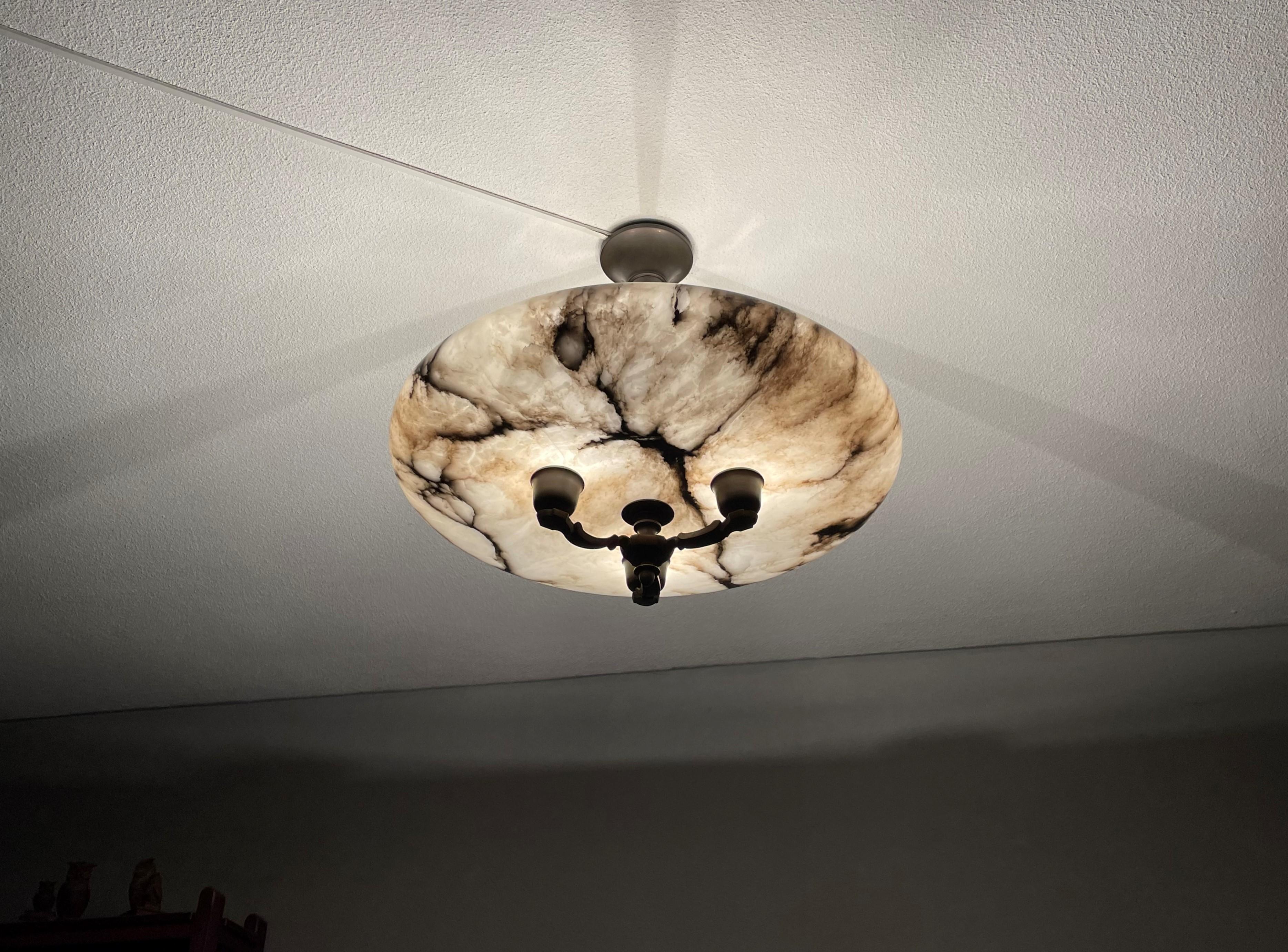 One of a kind and impressive size, three light alabaster flushmount.

This unique, extra large antique light fixture comes with a stunning, polished alabaster shade. This striking and very well balanced flush mount is designed in such a way that the