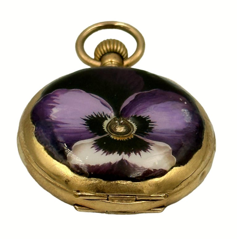 Antique enamel painted pansy on a gold locket case.  Faberge created pocket watch cases/locket cases and would send them to Switzerland for the watches to be inserted.  This one must have been a specially commissioned piece as it was done to