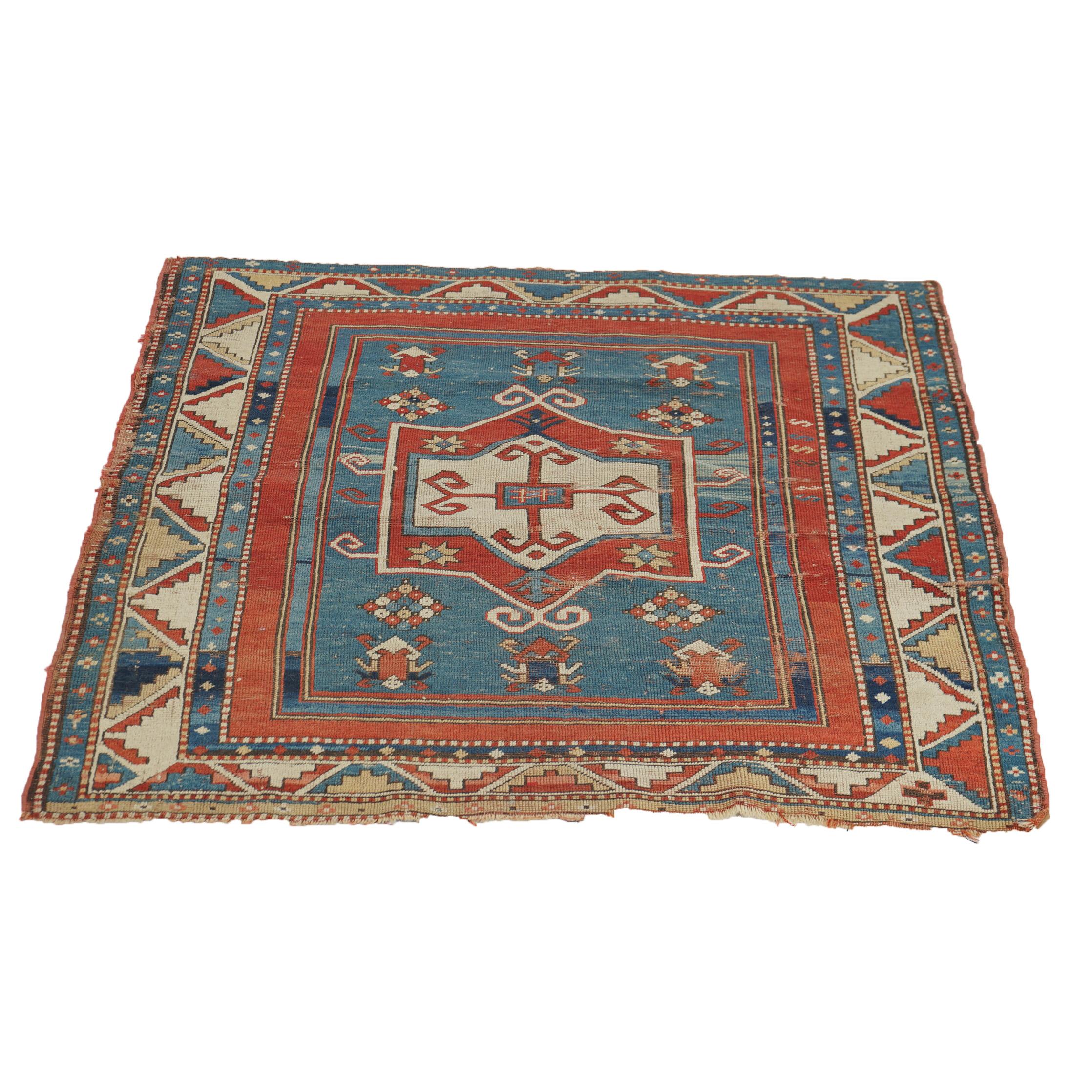 An antique Fachralo Kazak Caucasian oriental rug offers wool construction with tribal design having central medallion, rams horns, and geometric elements, c1900

Measures - 53